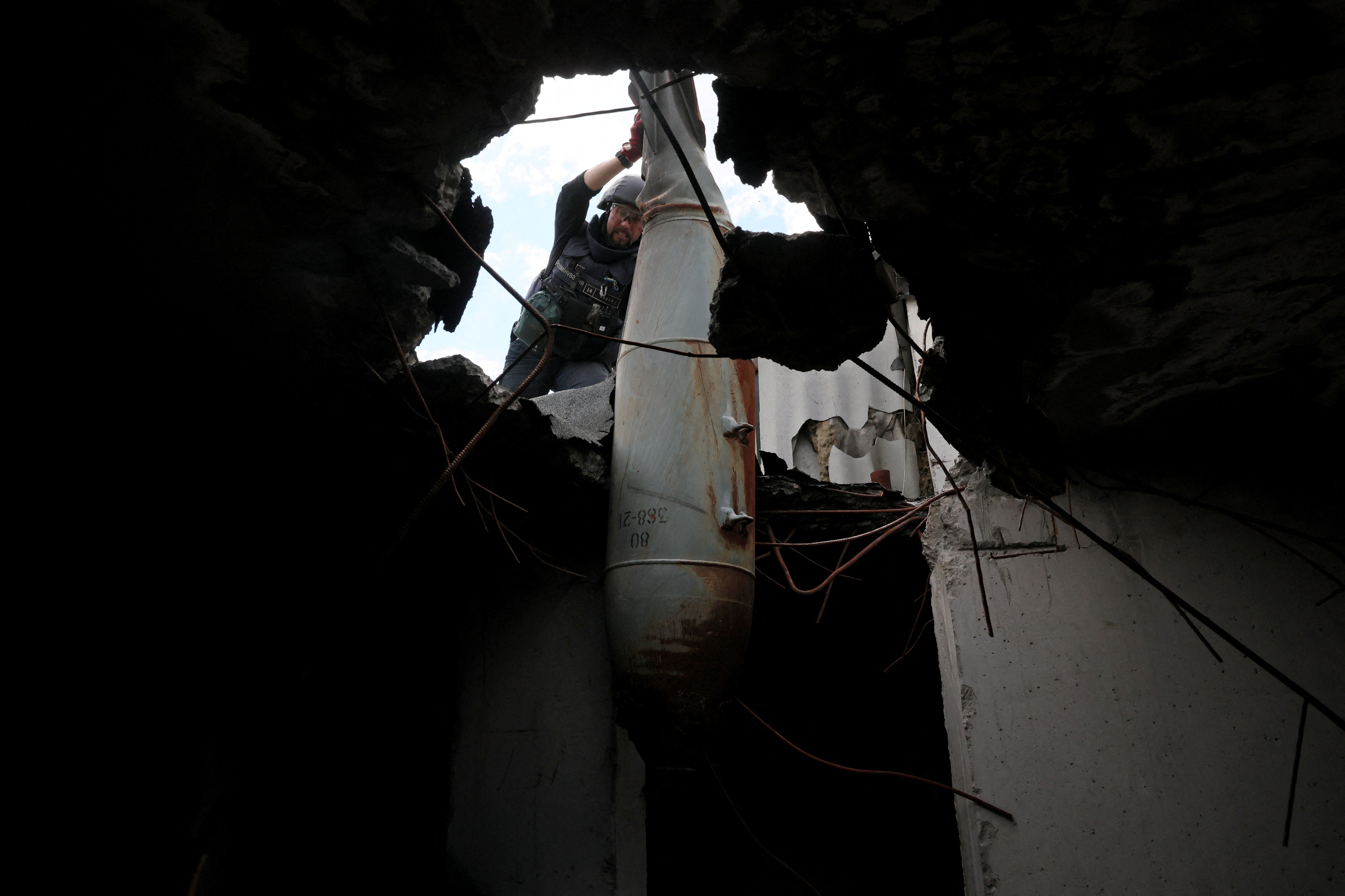 The bomb removal specialists begin removing the explosive from the apartment block