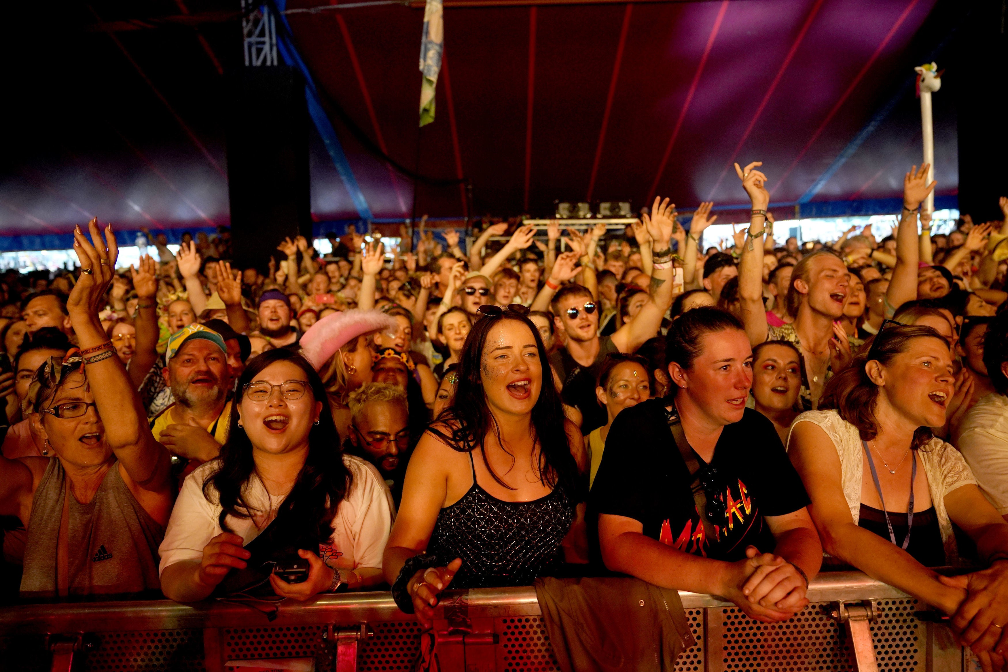 The crowd watch Glastonbury founder Michael Eavis performing with his band