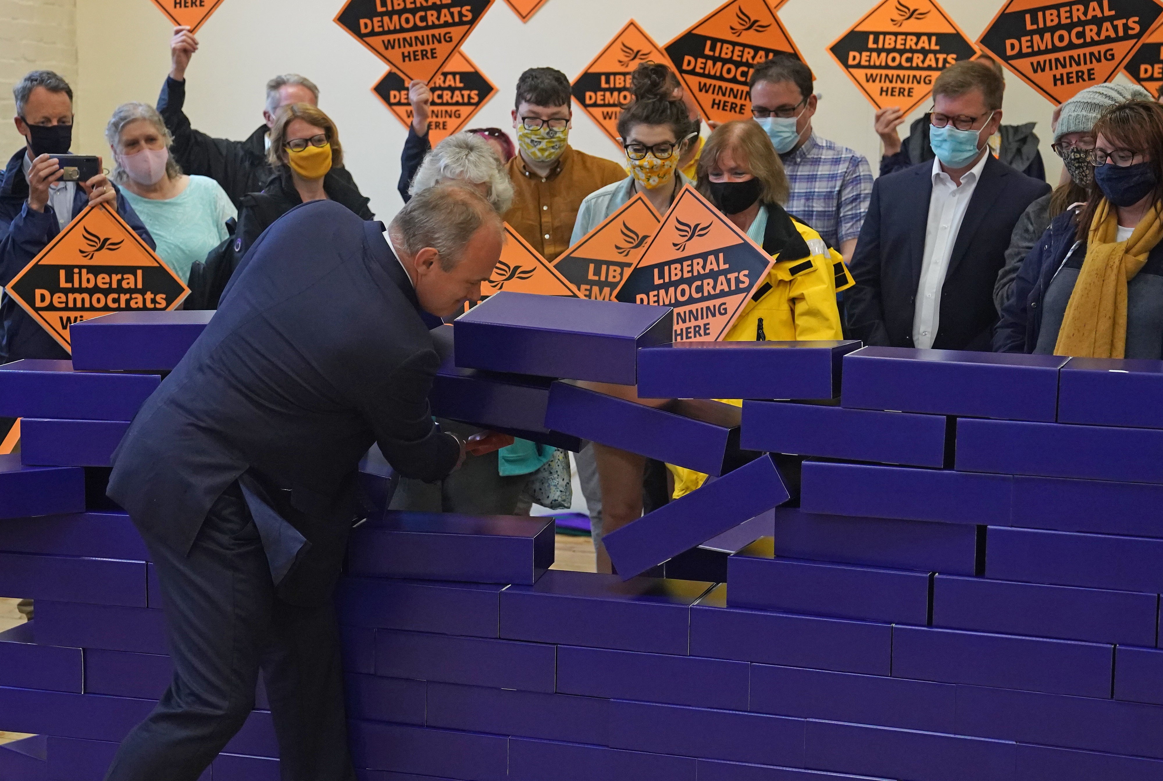 Ed Davey knocks down a blue wall after the Amersham and Chesham by-election with a B&Q hammer