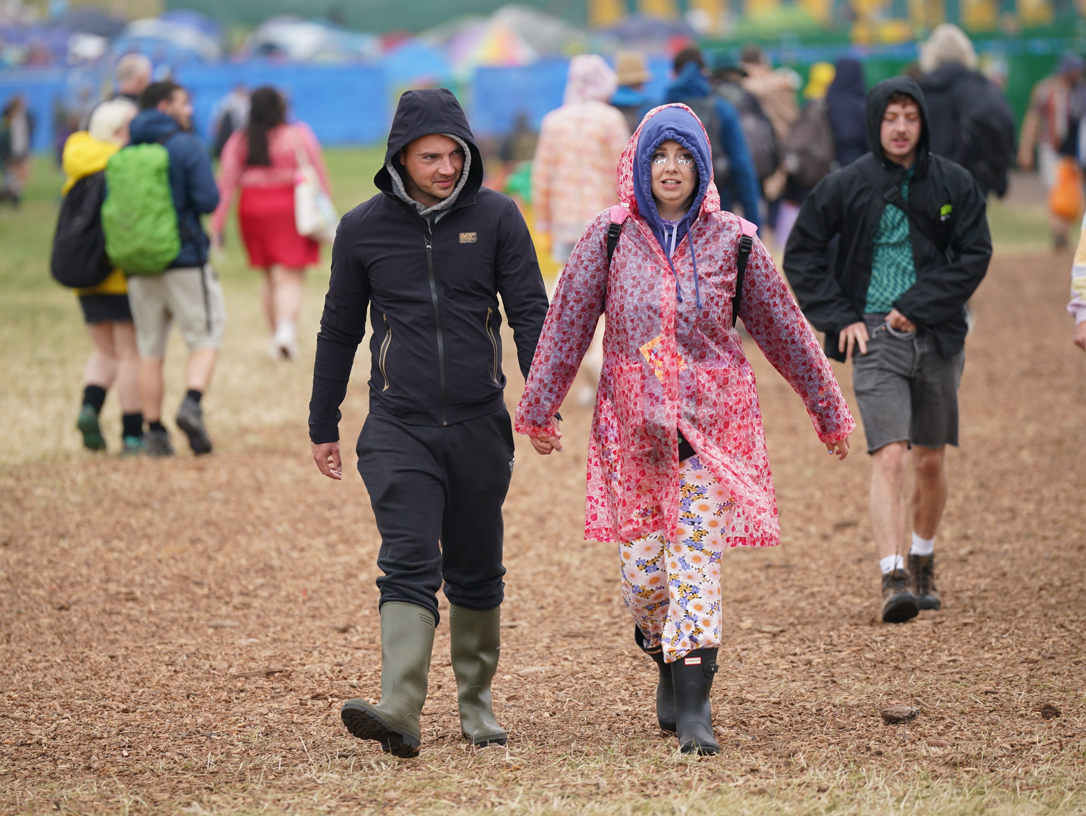 Festivalgoers in the rain during the Glastonbury Festival at Worthy Farm in Somerset (Yui Mok/PA)