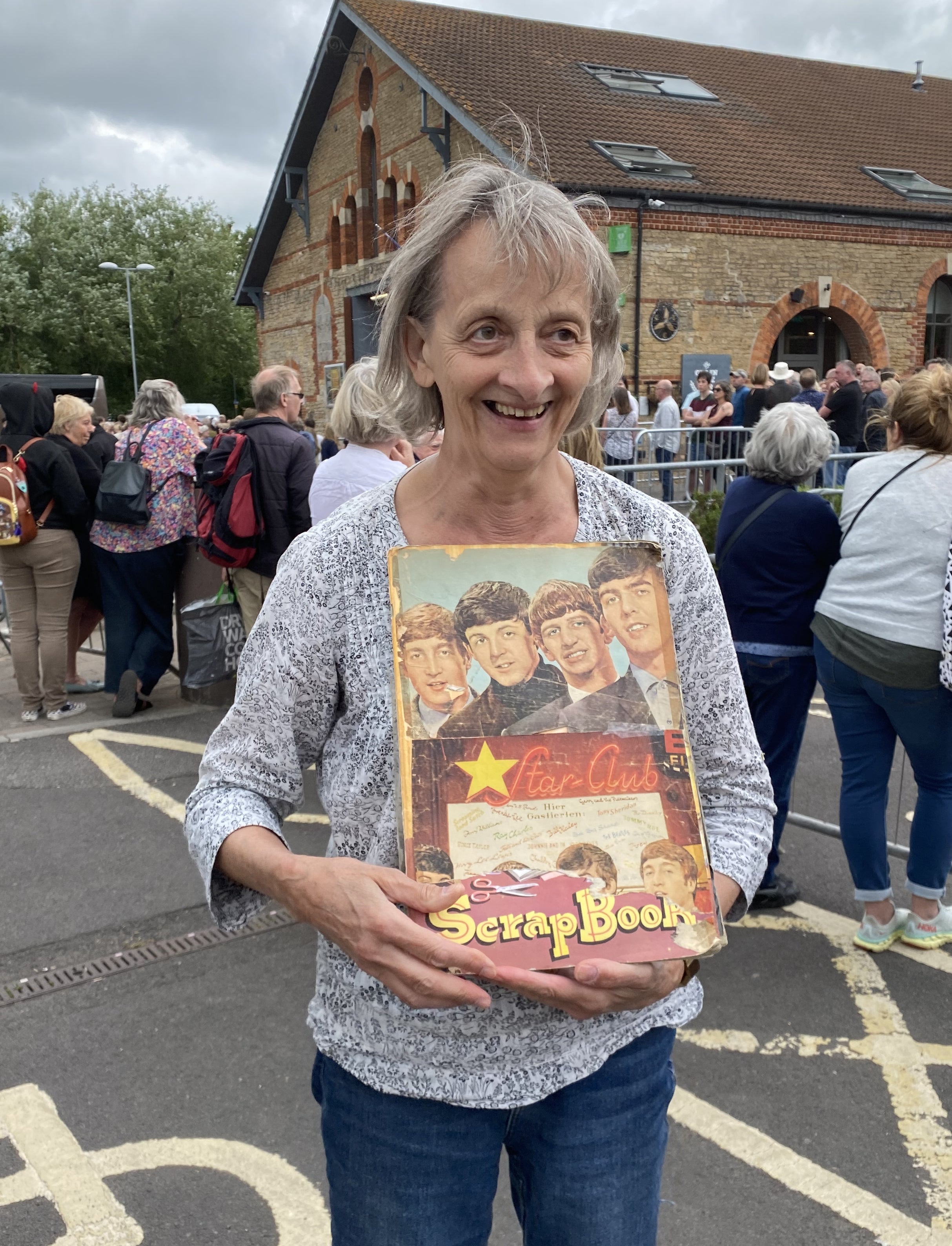 Superfan Jane Lamb waited outside the venue with her Beatles scrapbook which she had made aged eight (Connie Evans/PA)