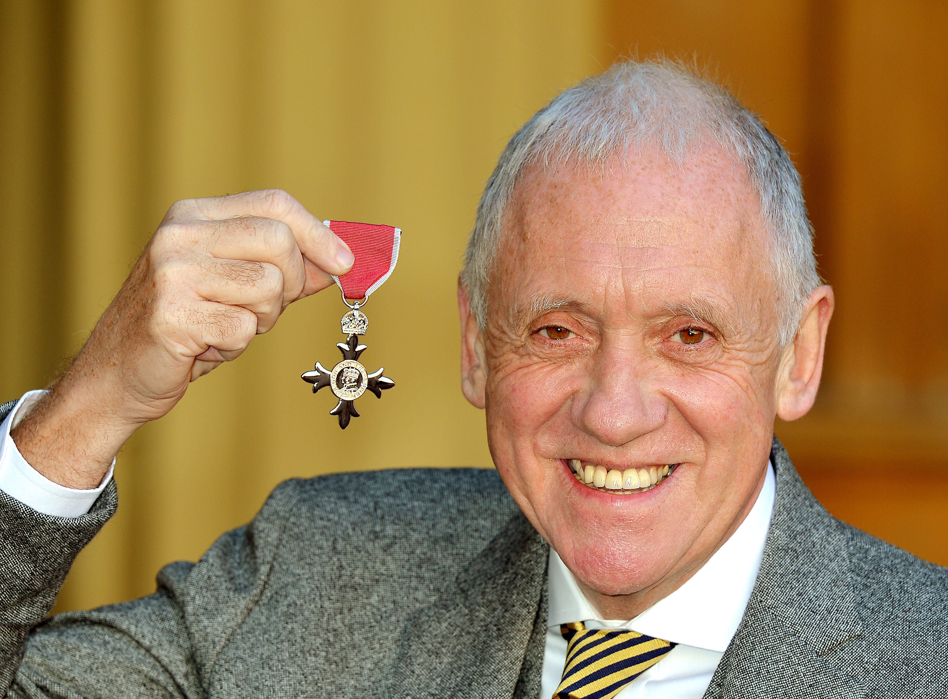 Harry Gration holding his MBE presented to him by the Prince of Wales (John Stillwell/PA)