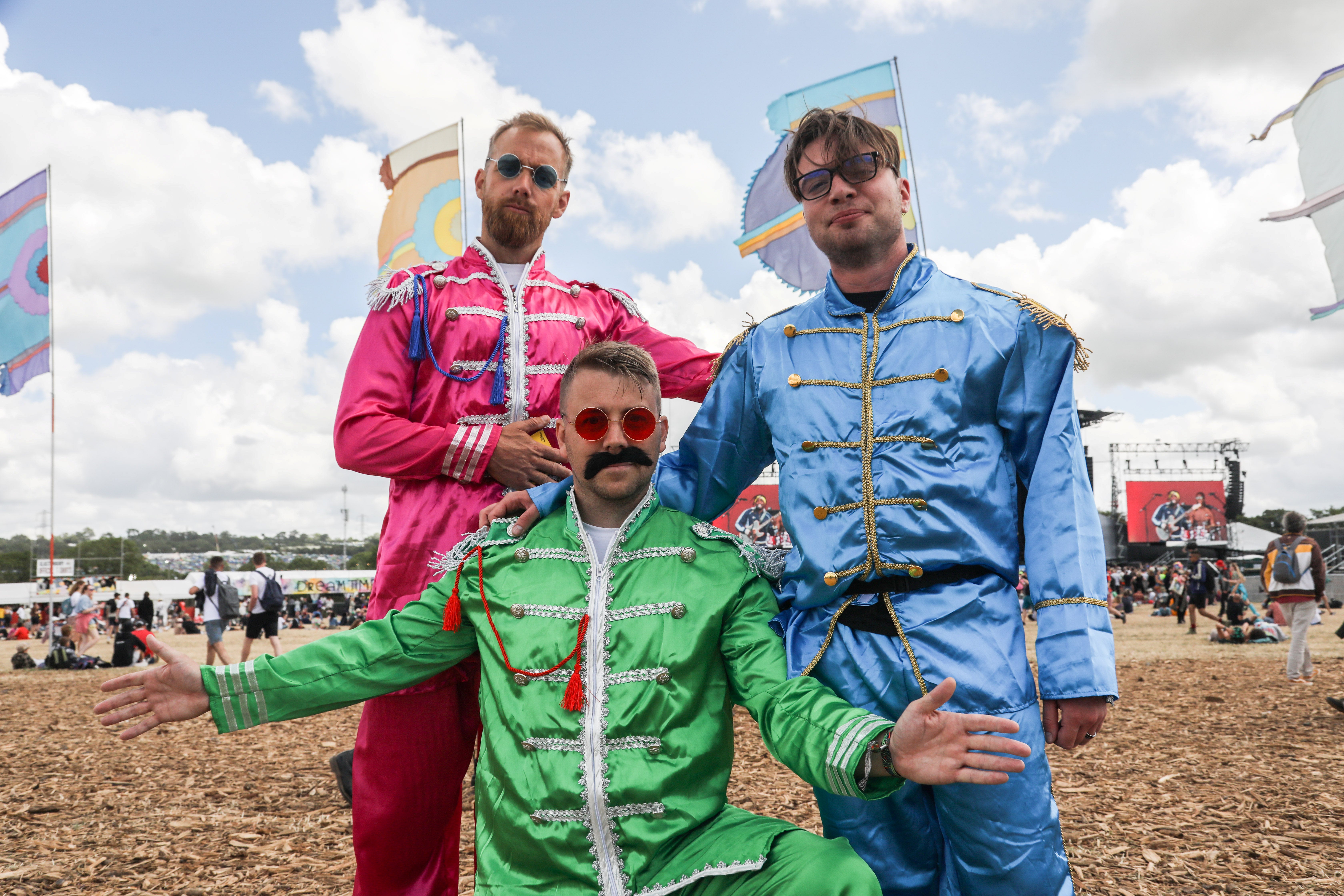 Festivalgoers dressed as the Beatles ready for headliner Paul McCartney