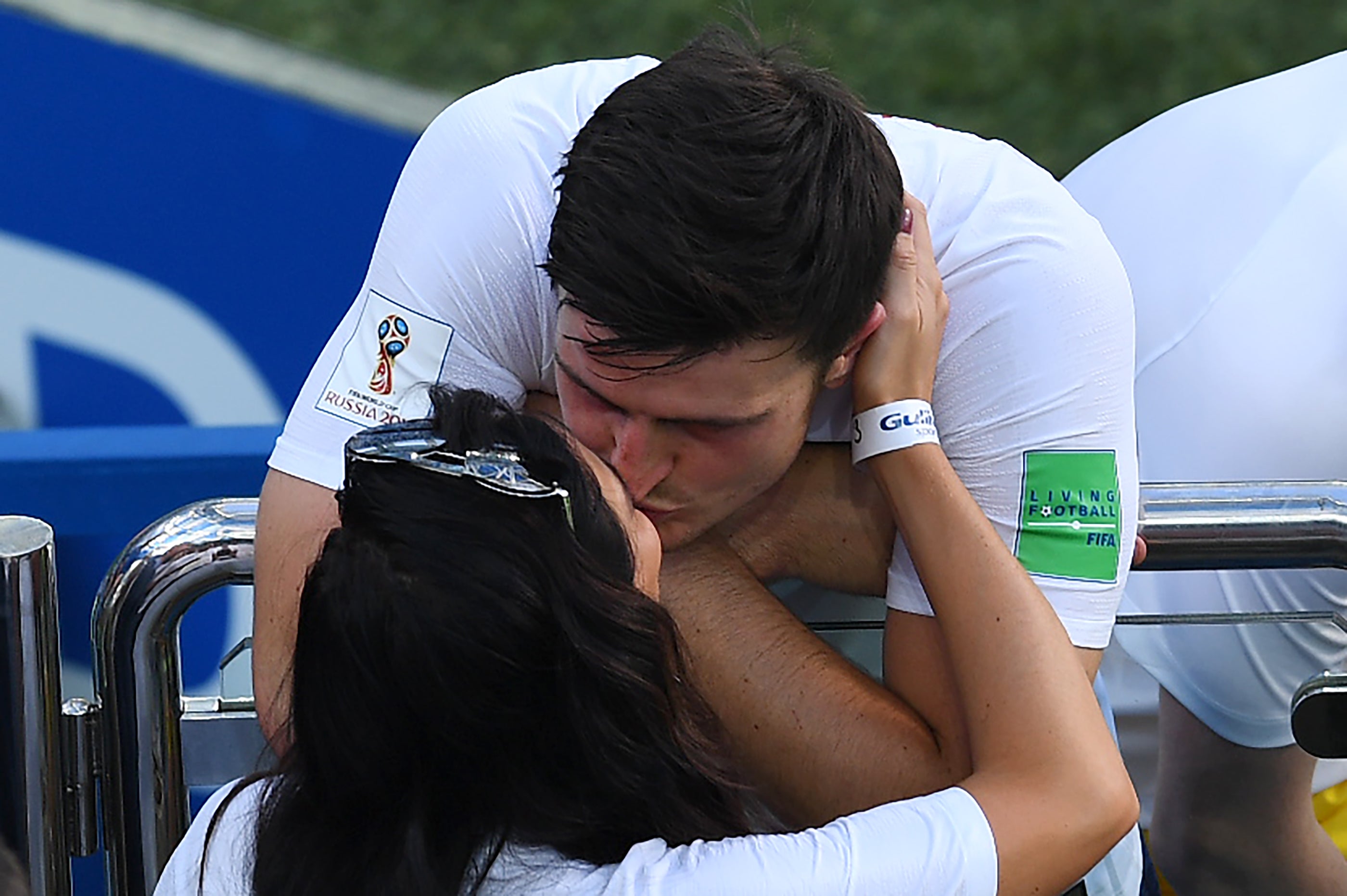 England's defender Harry Maguire kisses his girlfriend Fern Hawkins after the Russia 2018 World Cup