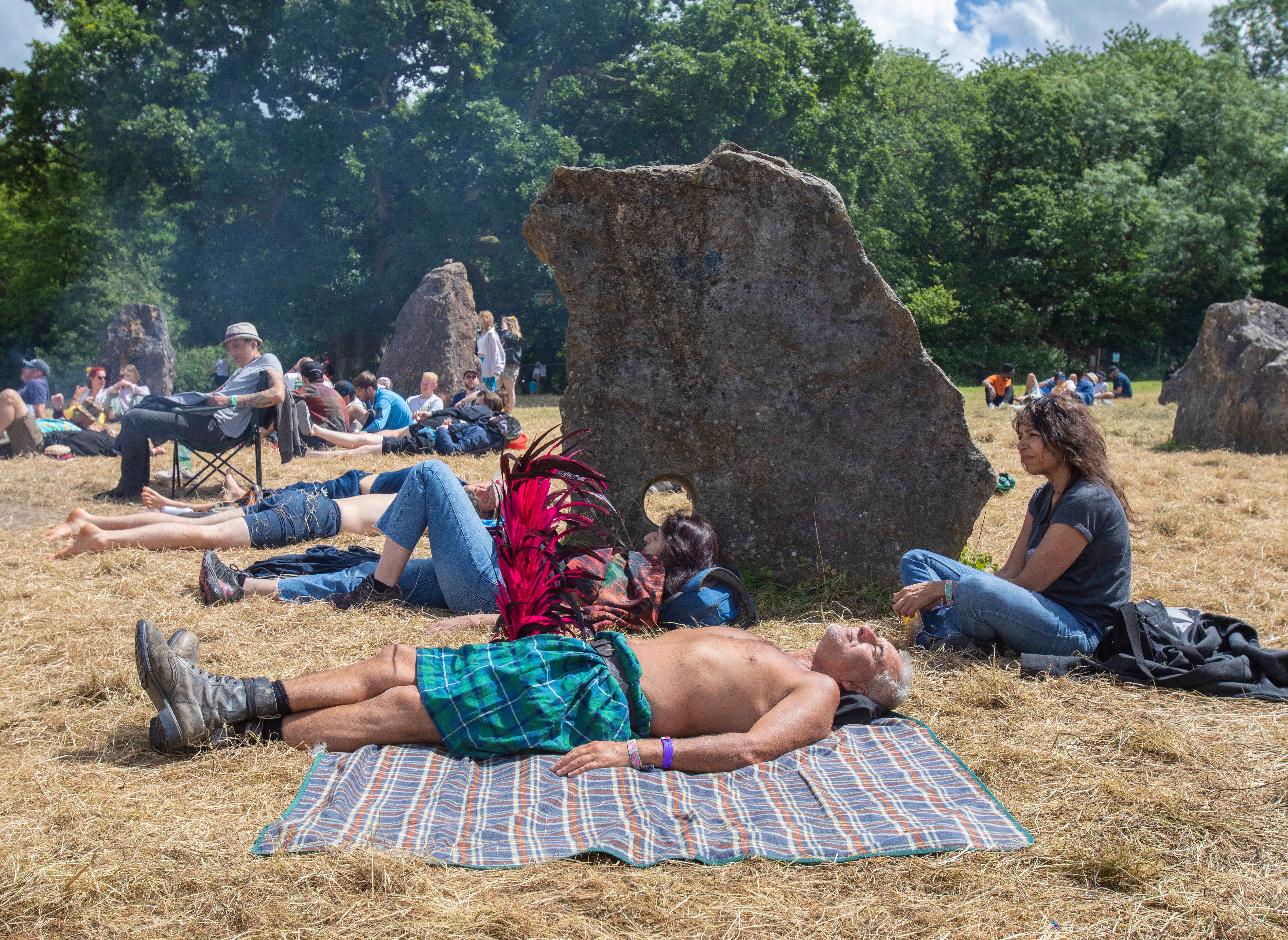 A festivalgoer relaxes in the Stone Circle