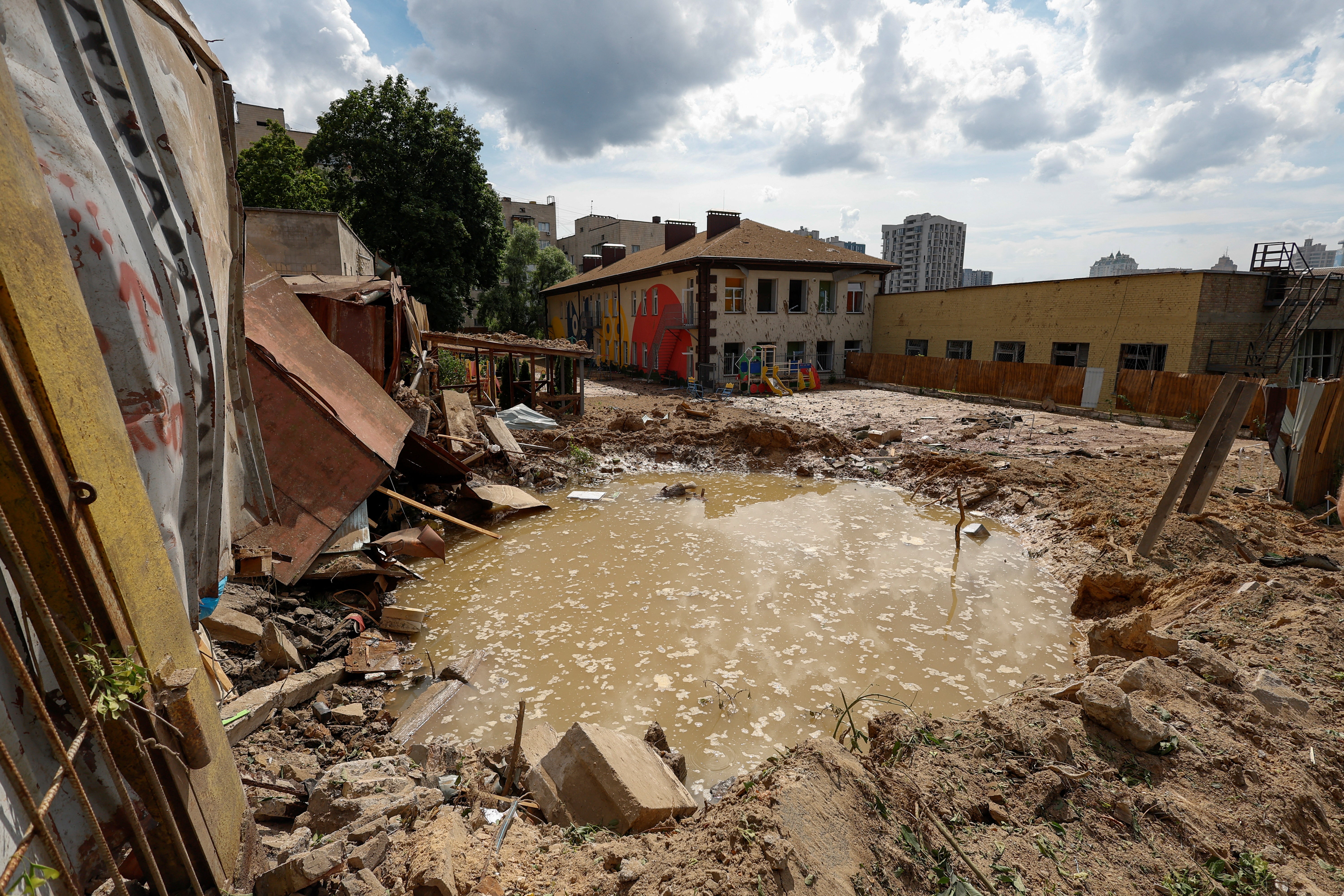 A crater is seen at a compound of a kindergarten after a Russian missile strike