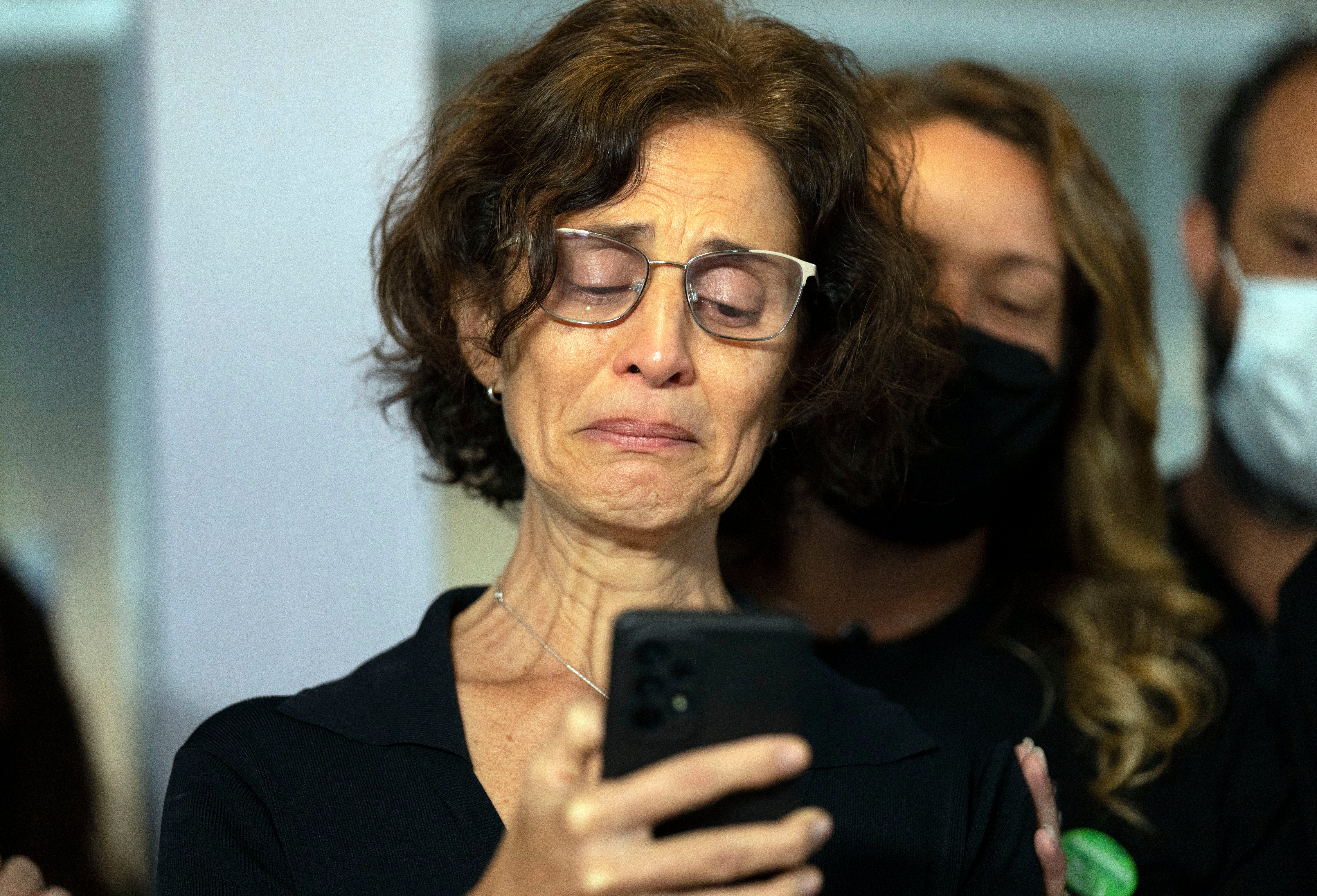 Alessandra Sampaio speaks to the media during the funeral of her husband