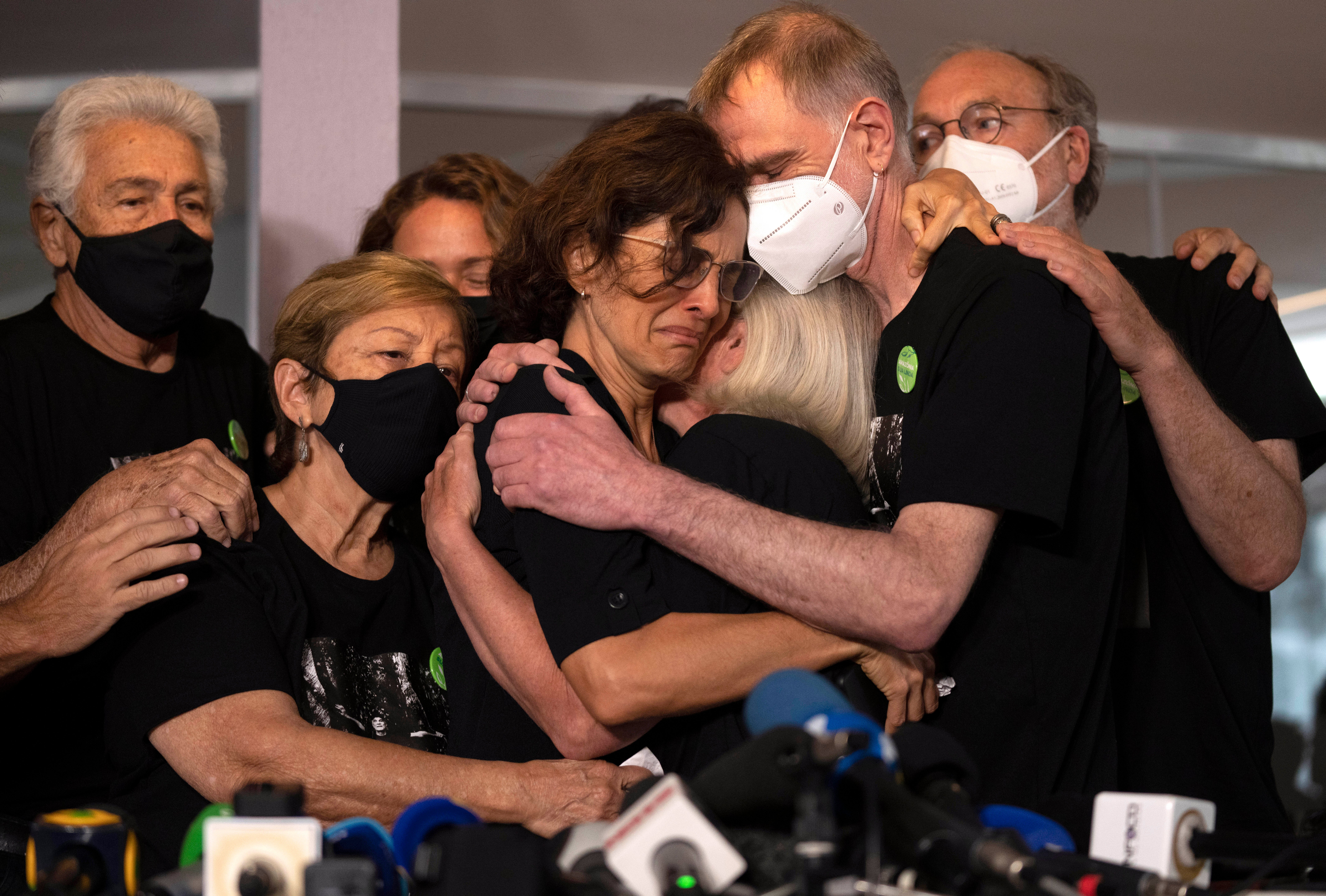 Relatives mourn as Alessandra Sampaio, centre, embraces her sister-in-law Sian Phillips
