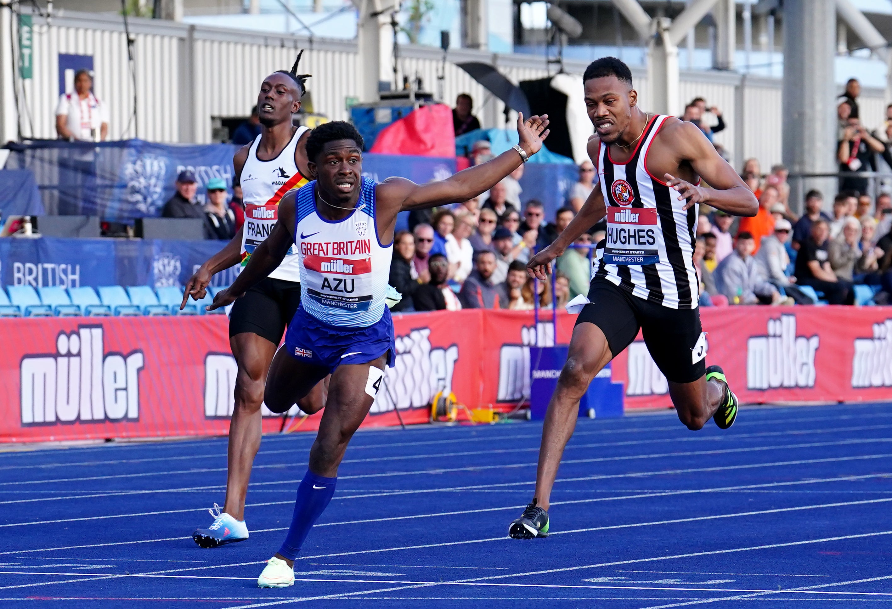 Jeremiah Azu, centre, was the men’s 100m champion in Manchester (Martin Rickett/PA)