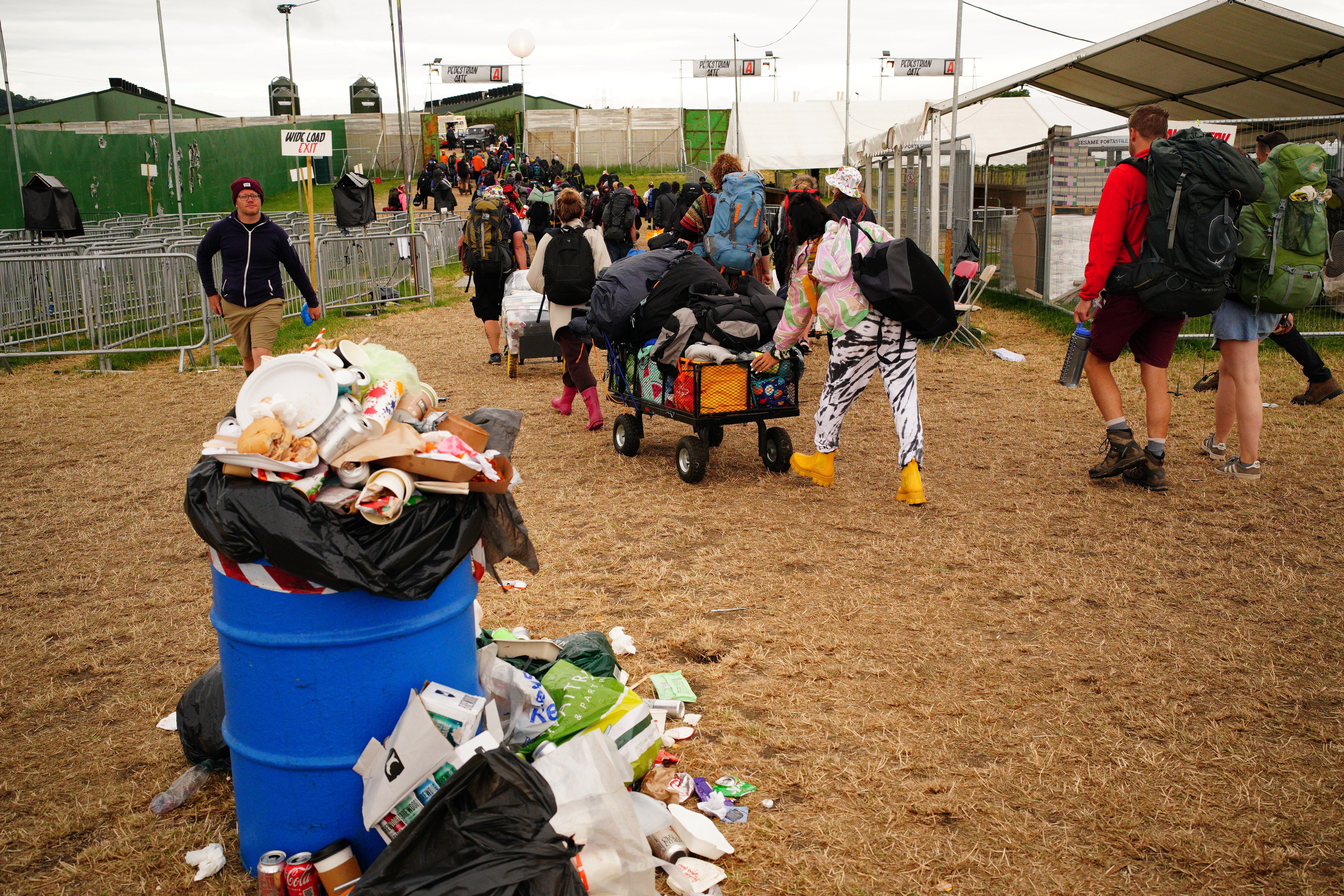 Festival-goers leave Worthy Farm in Somerset following the Glastonbury Festival (Ben Birchall/PA)