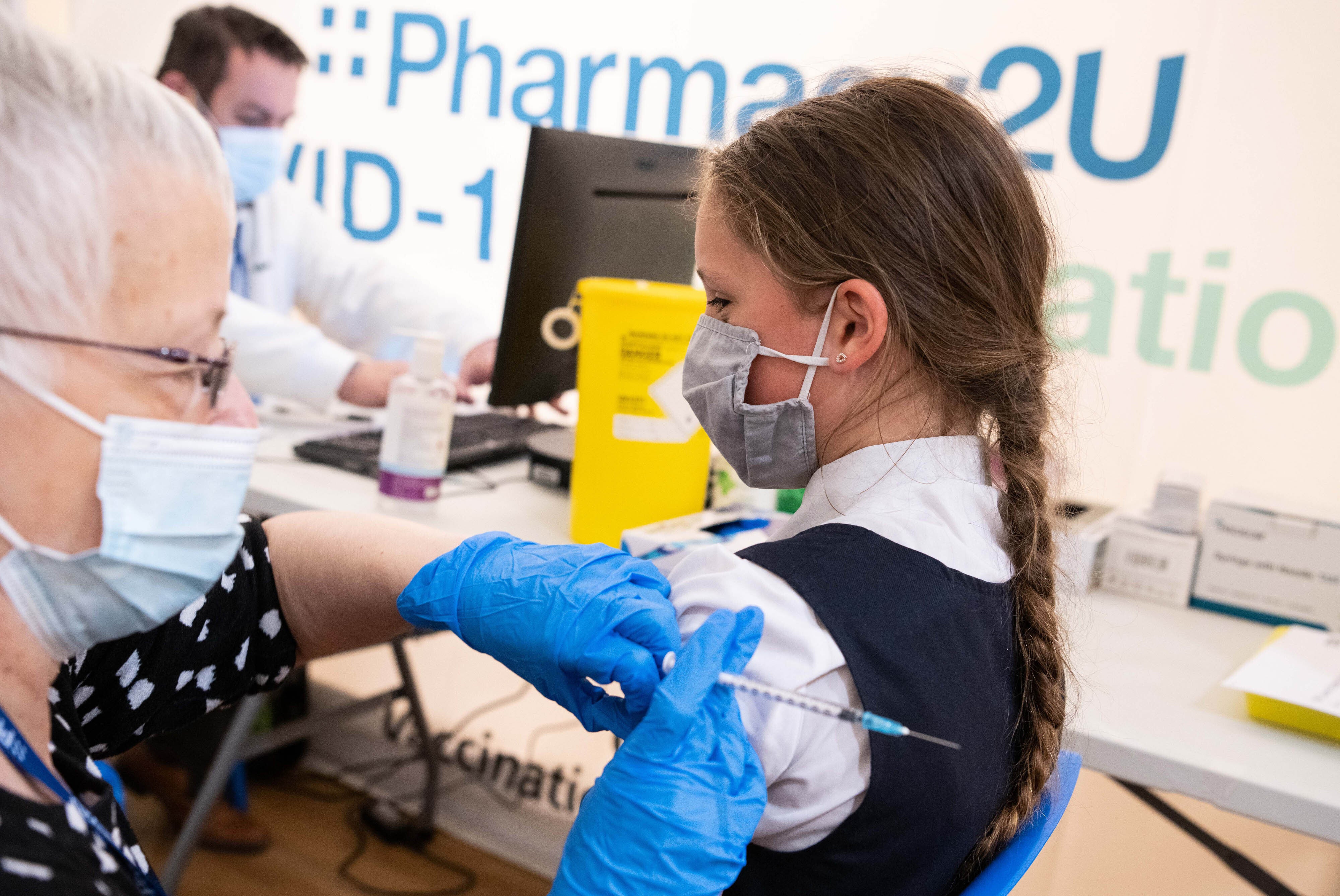 A school pupil having a Covid vaccine (PA)