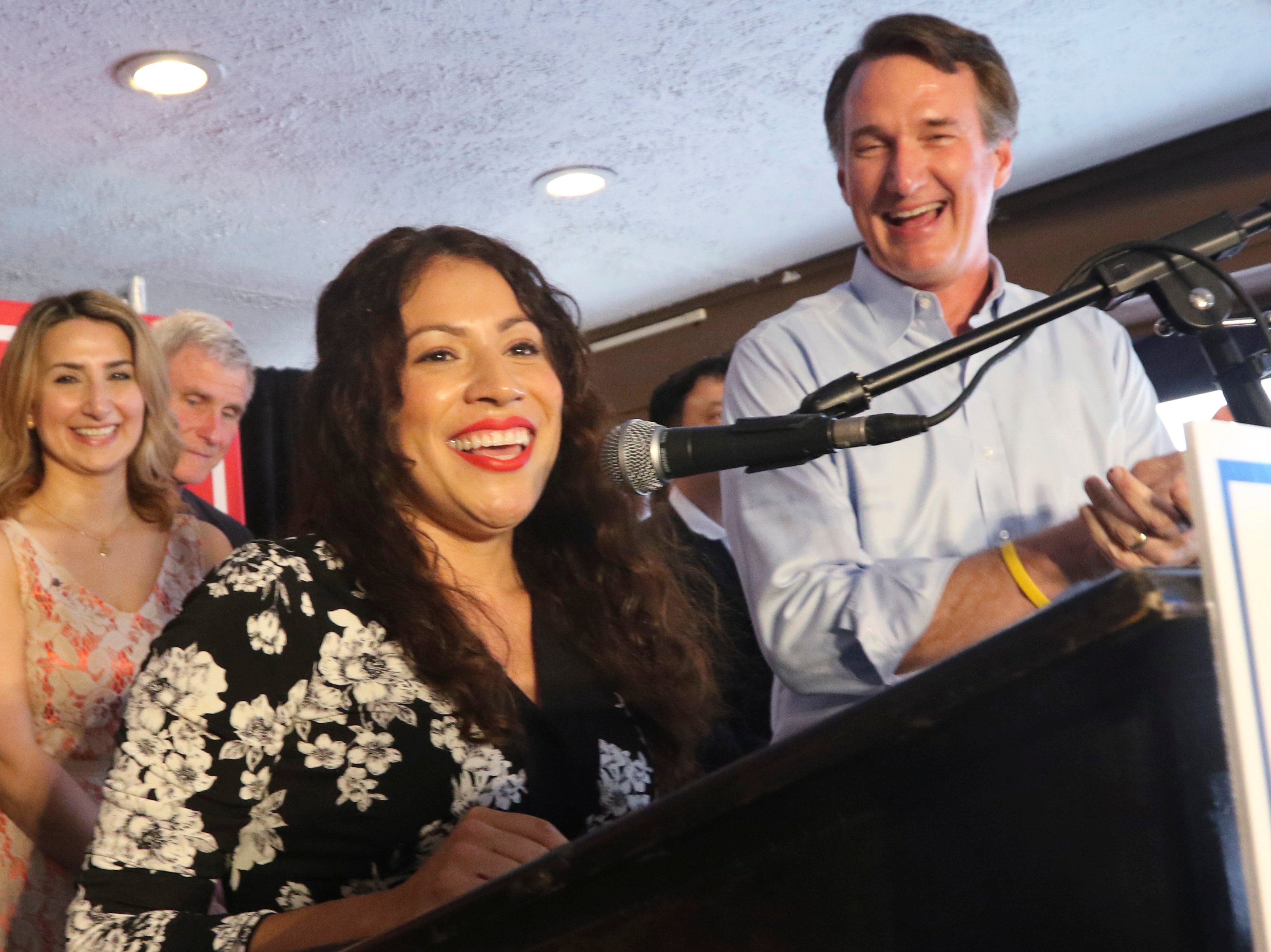 Winner of Tuesday's Republican primary for the 7th district congressional race, Yesli Vega, left, speaks to the crows along with Virginia Gov. Glenn Youngkin at a restaurant Wednesday, June 22, 2022, in Woodbridge, Va