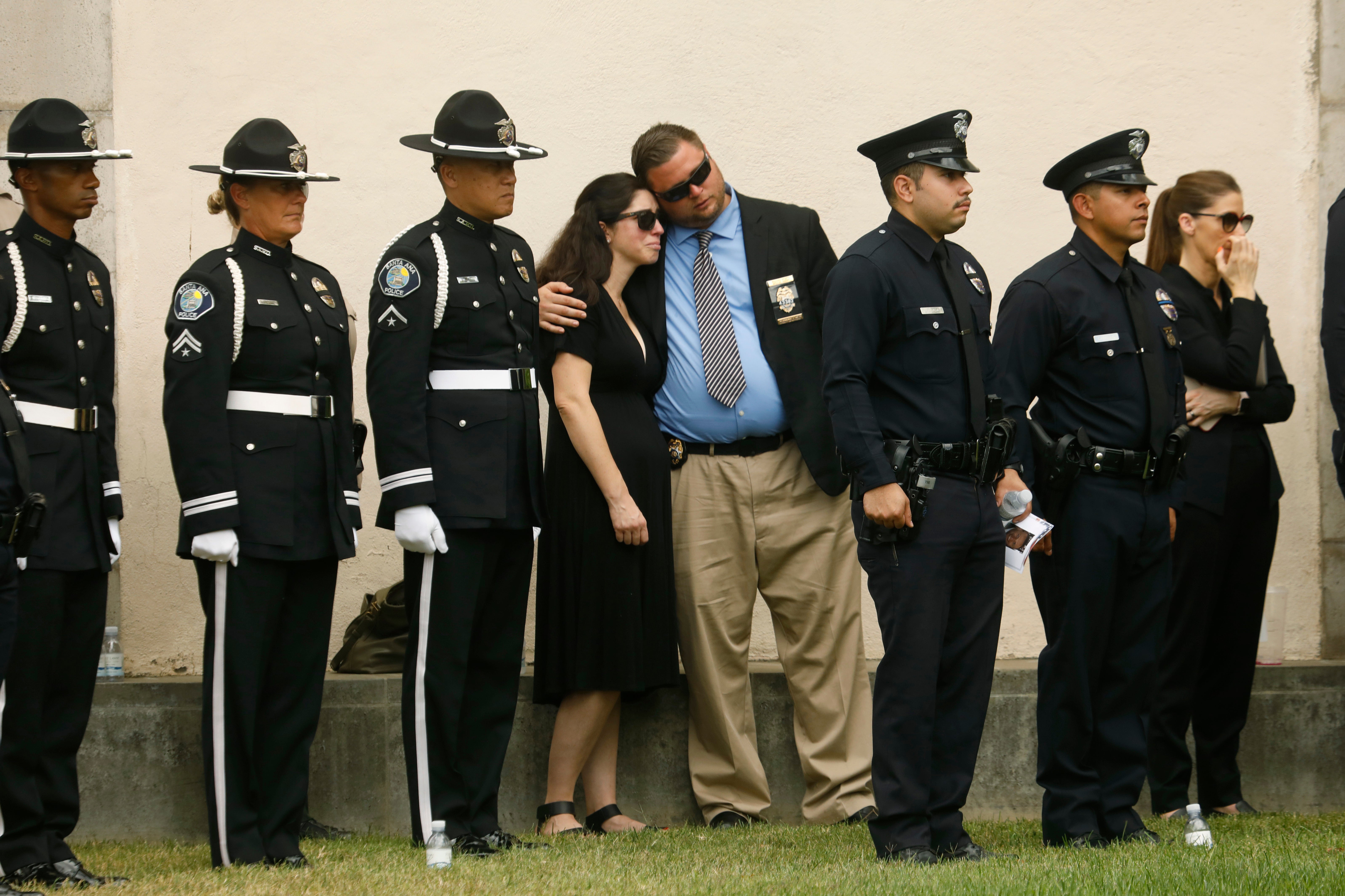 Family, friends, city officials and fellow officers salute fallen Los Angeles Police Officer Houston Tipping as they gather at Forest Lawn Hollywood Hills - Hall of Liberty Mosaic Deck for his funeral Wednesday, June 22, 2022, in Los Angeles