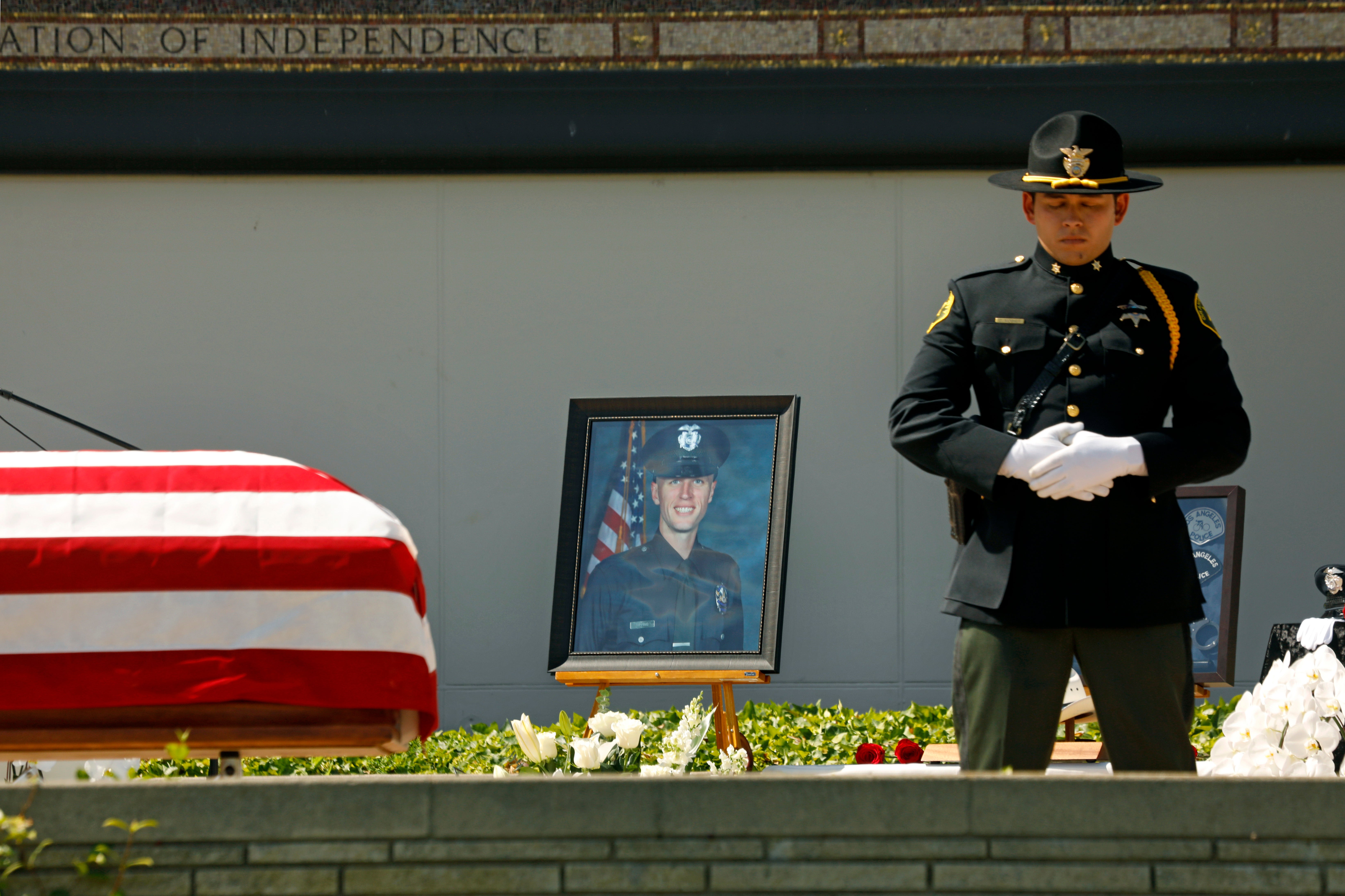 Family, friends, city officials and fellow officers salute fallen Los Angeles Police Officer Houston Tipping as they gather at Forest Lawn Hollywood Hills - Hall of Liberty Mosaic Deck for his funeral Wednesday, June 22, 2022, in Los Angeles