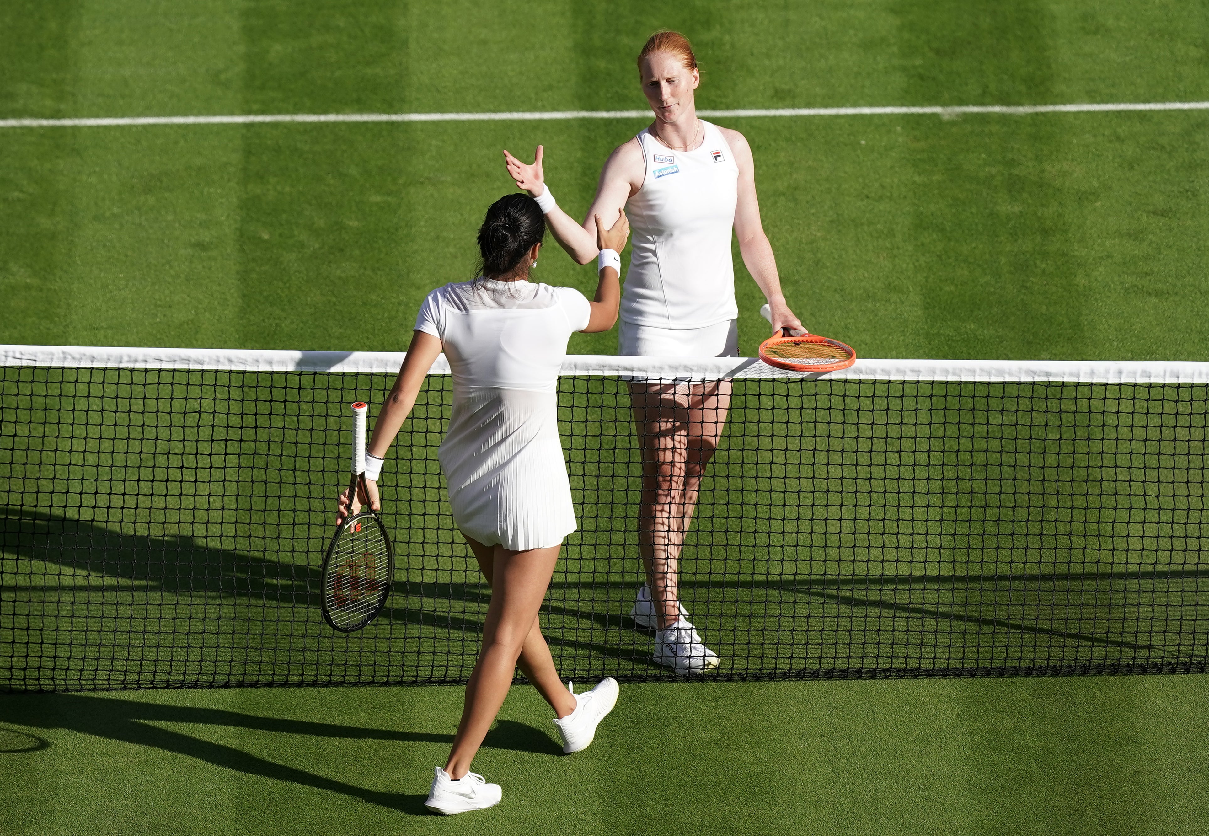 Emma Raducanu shakes hands with Alison Van Uytvanck after her victory (Aaron Chown/PA)