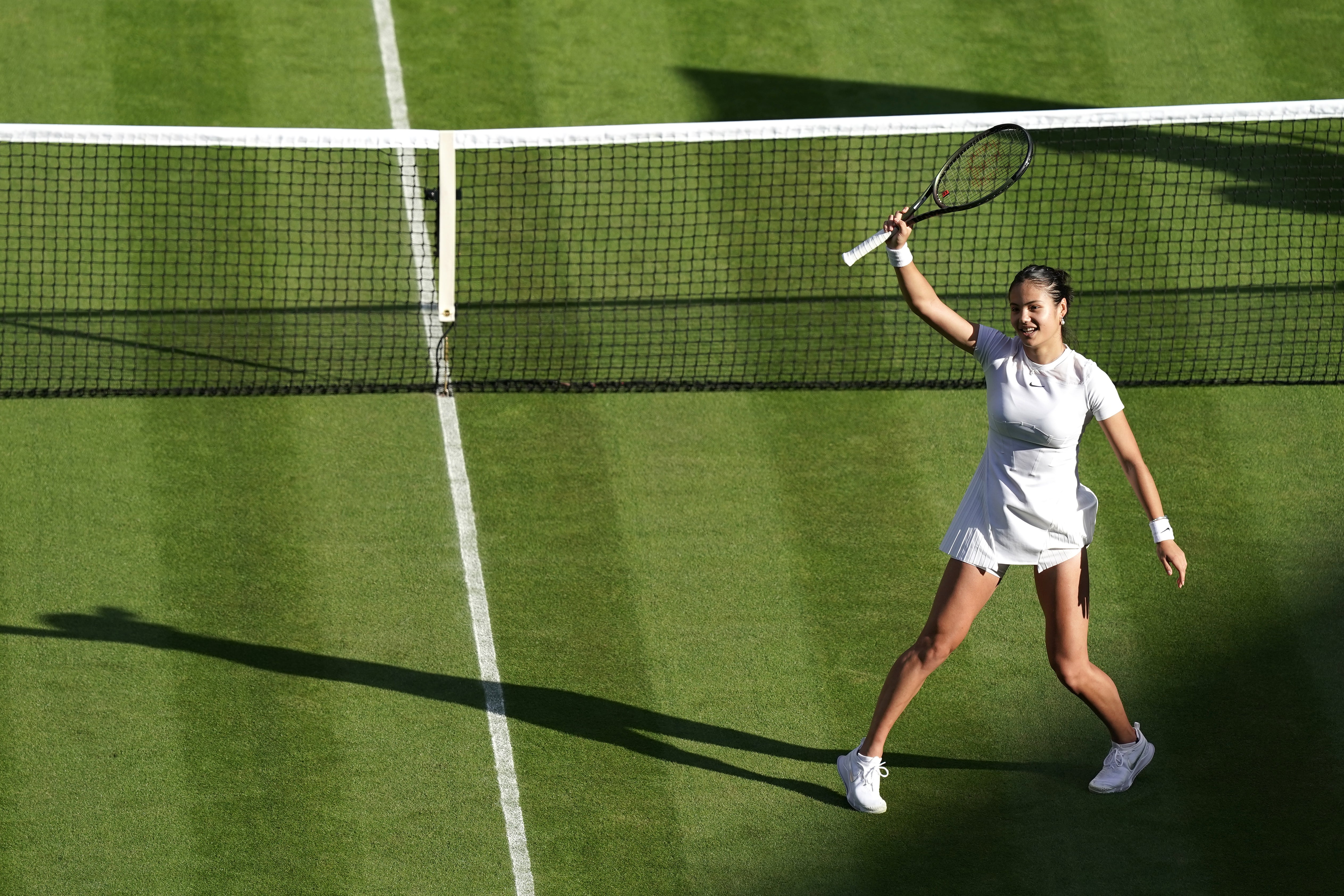 Emma Raducanu waves to Centre Court after her debut victory (Aaron Chown/PA)