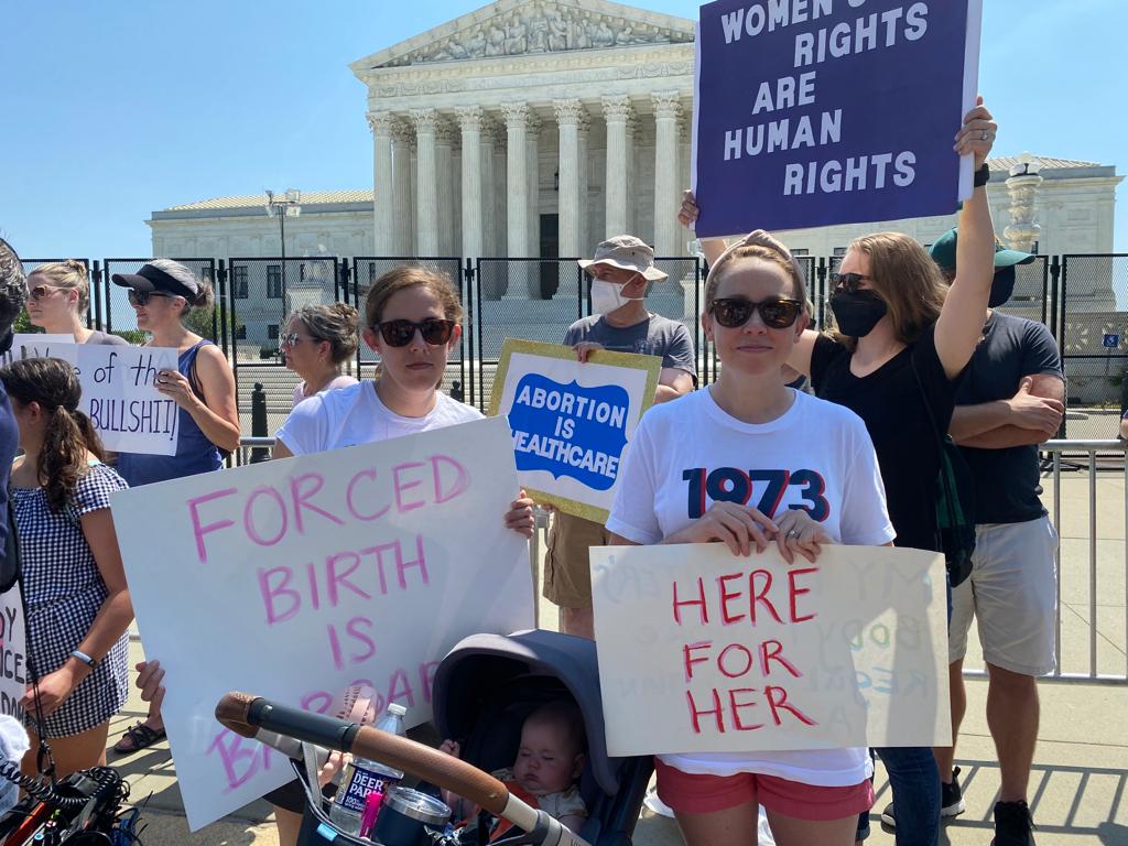 Zoe (right) with her baby daughter Matilda outside the Supreme Court on Sunday