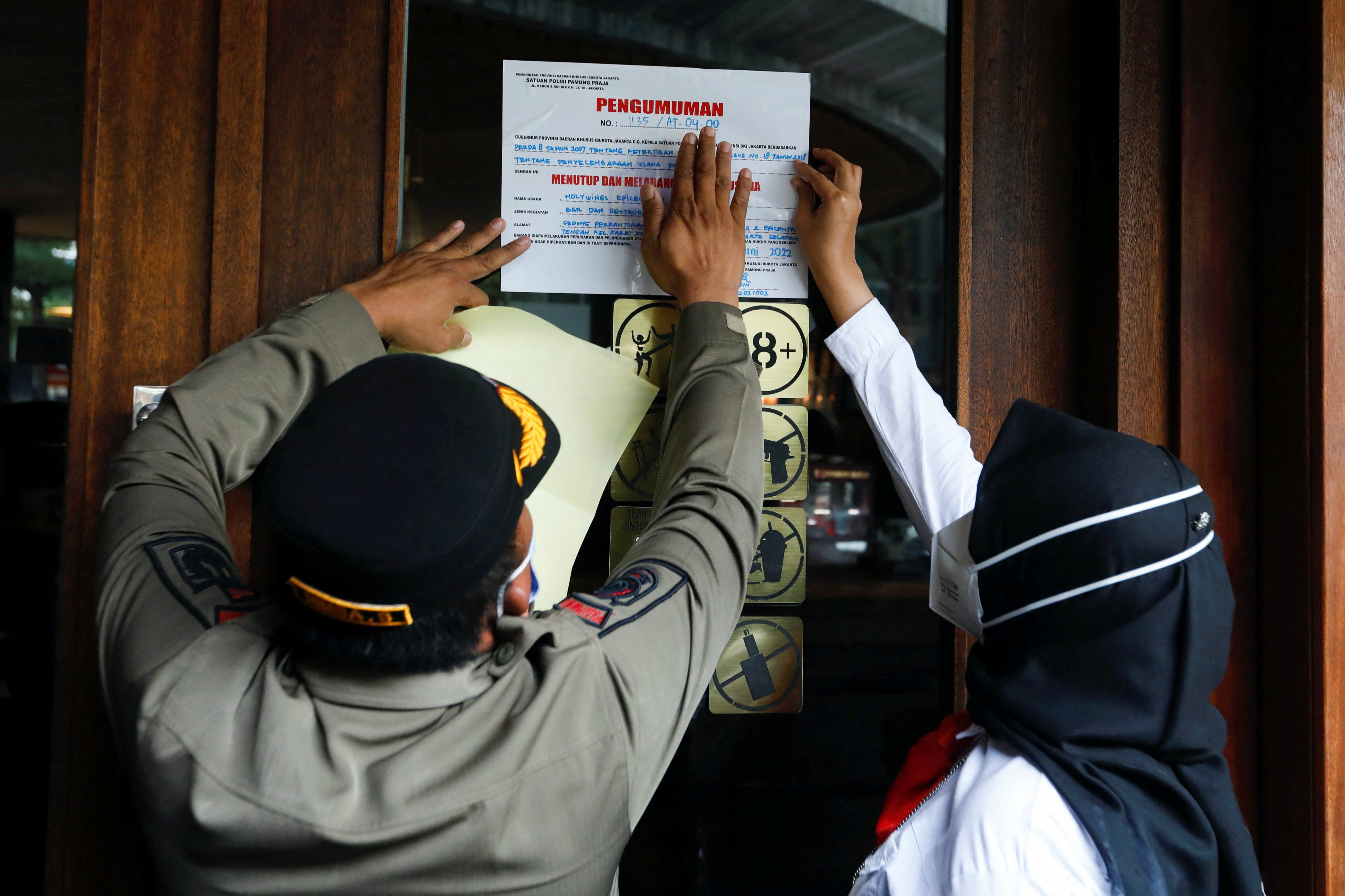 Municipal officers seal the Holywings bar