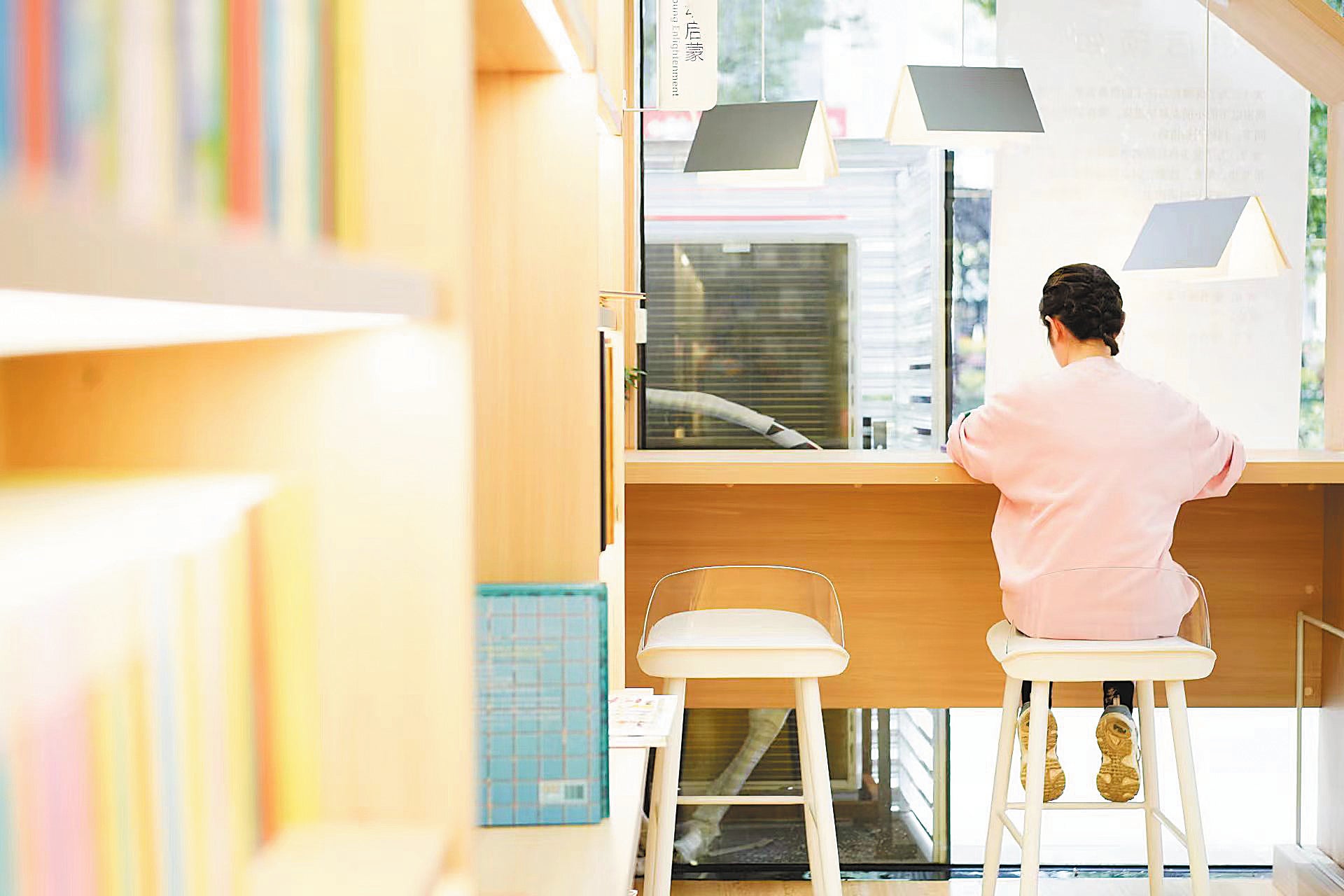 A visitor reads in the store’s reading zone