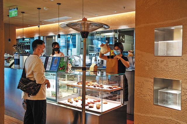 <p> A customer buys takeaway food and drink at the Buna & Pate coffee shop in Shanghai on June 8   </p>