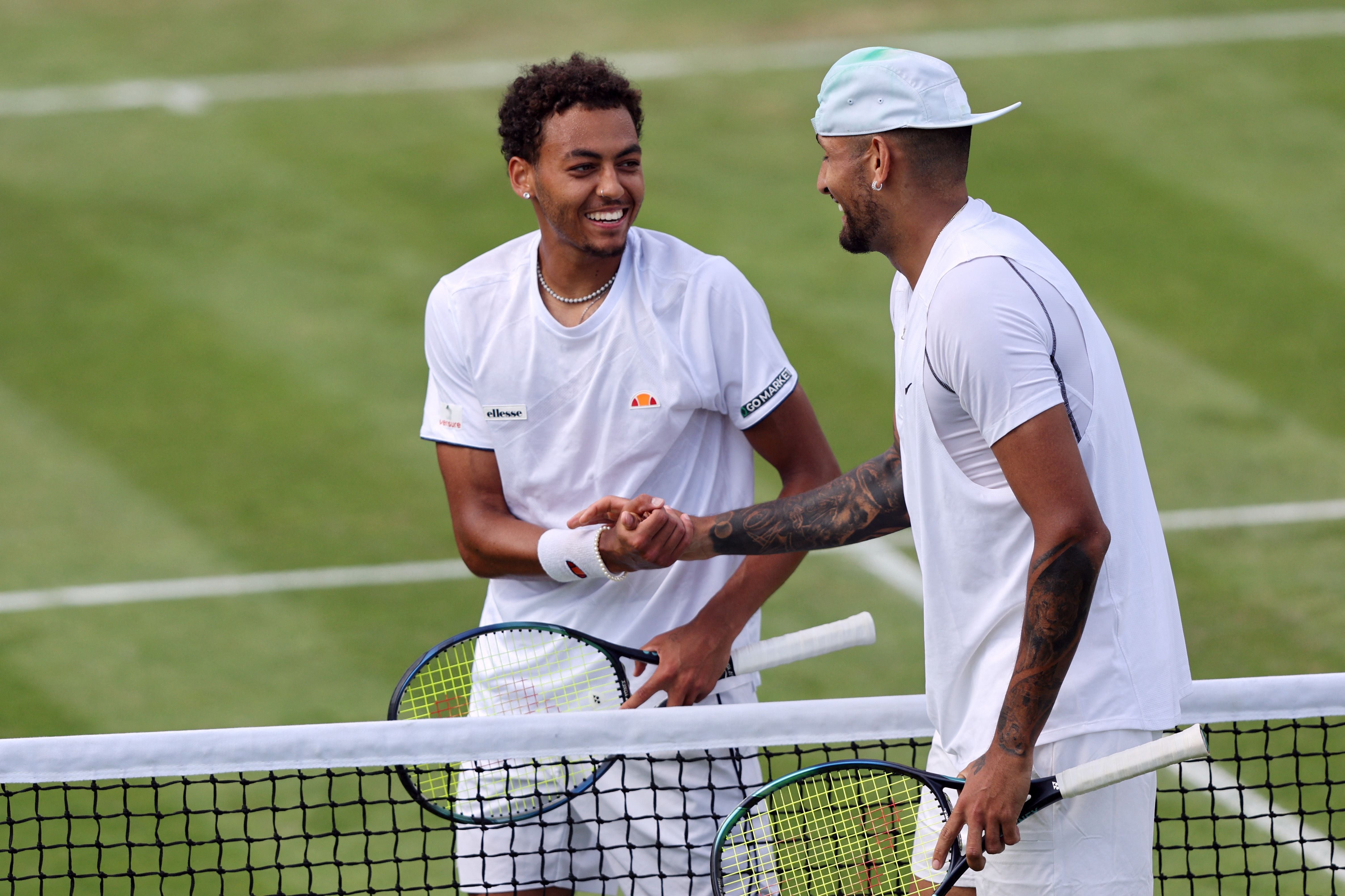 Australia's Nick Kyrgios (R) shakes hands with Britain's Paul Jubb