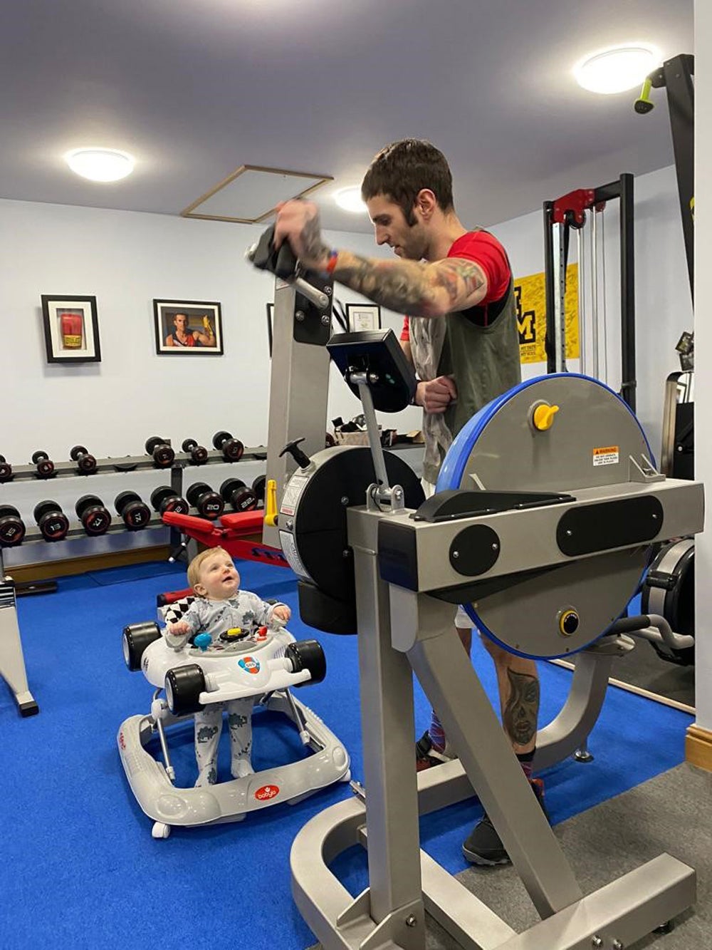 Bertie Wood, 16 months, watching his dad, Kieran Wood, working out in his home gym (Collect/PA Real Life)