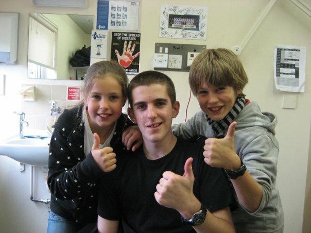 Kieran Wood in hospital in 2007 after the crash, with his brother, Rory Wood and sister, Freya Wood (Collect/PA Real Life)