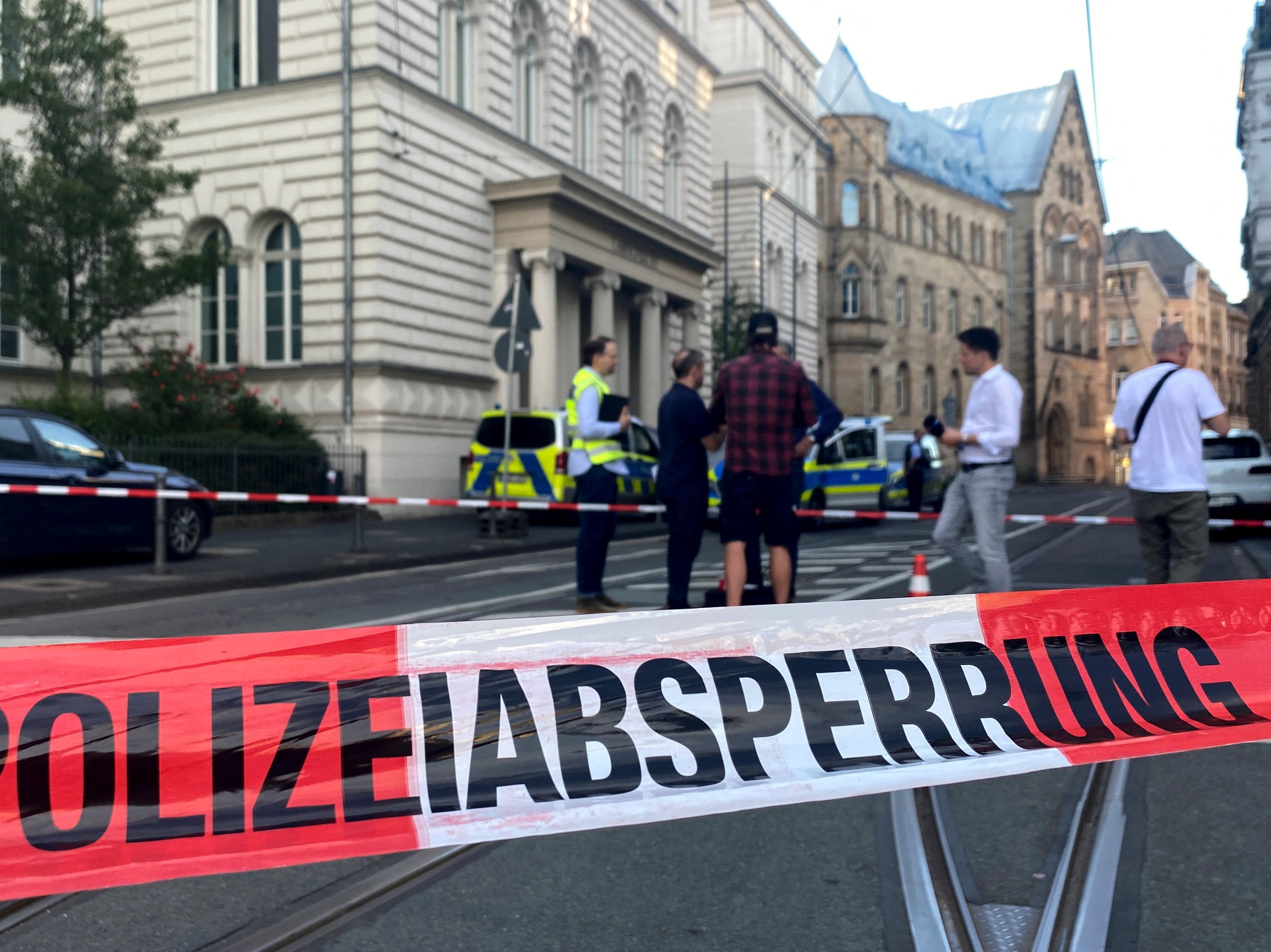 Police secure the area around a district court after a man left a severed human head in front of the building in Bonn, western Germany