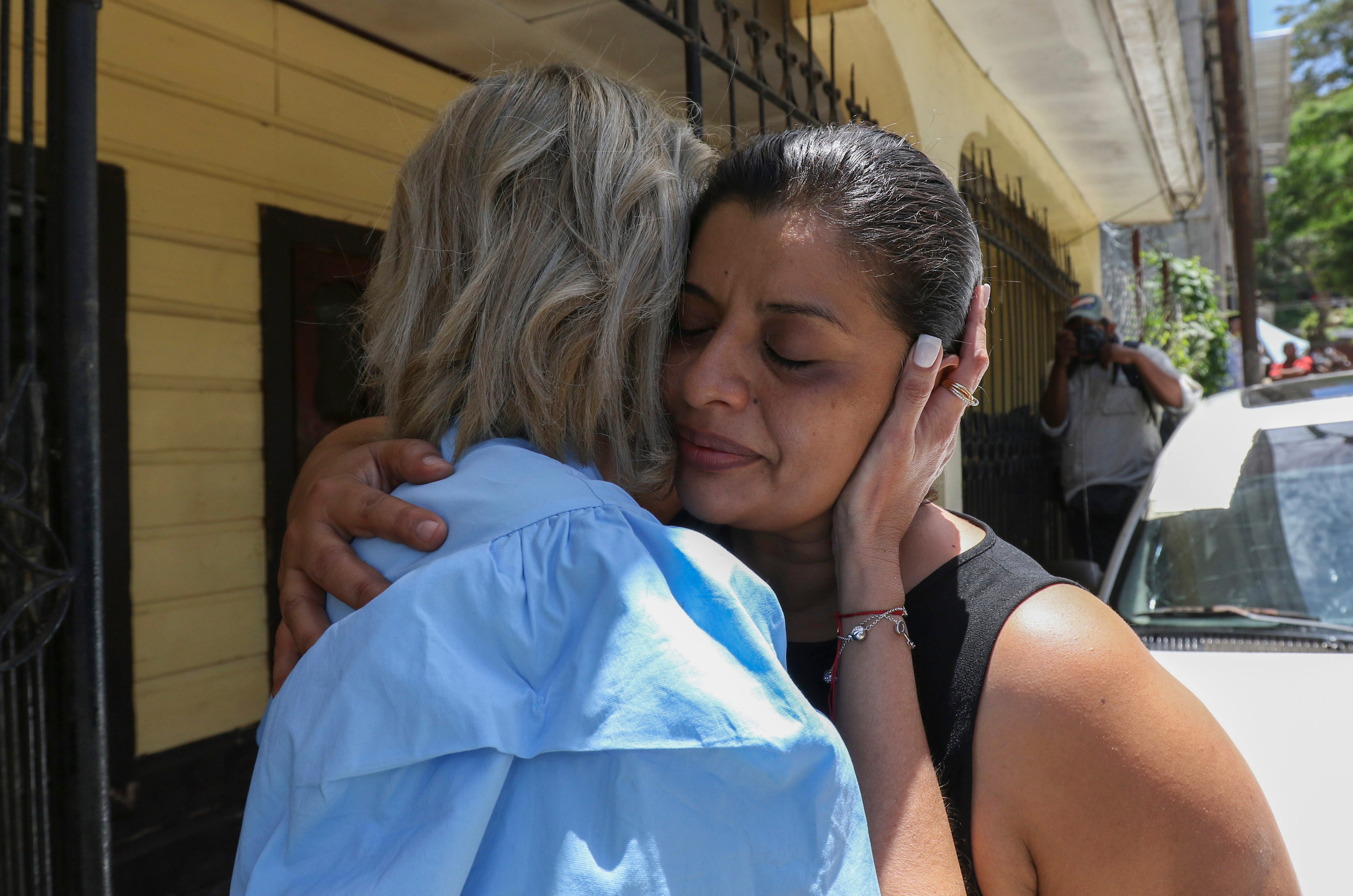 Karen Caballero, the mother of Fernando Redondo Caballero and Alejandro Andino Caballero who died near San Antonio, Texas, after being discovered in a hot trailer full of migrants being smuggled into the US, is comforted during an impromptu conference at their home in Las Vegas, Honduras