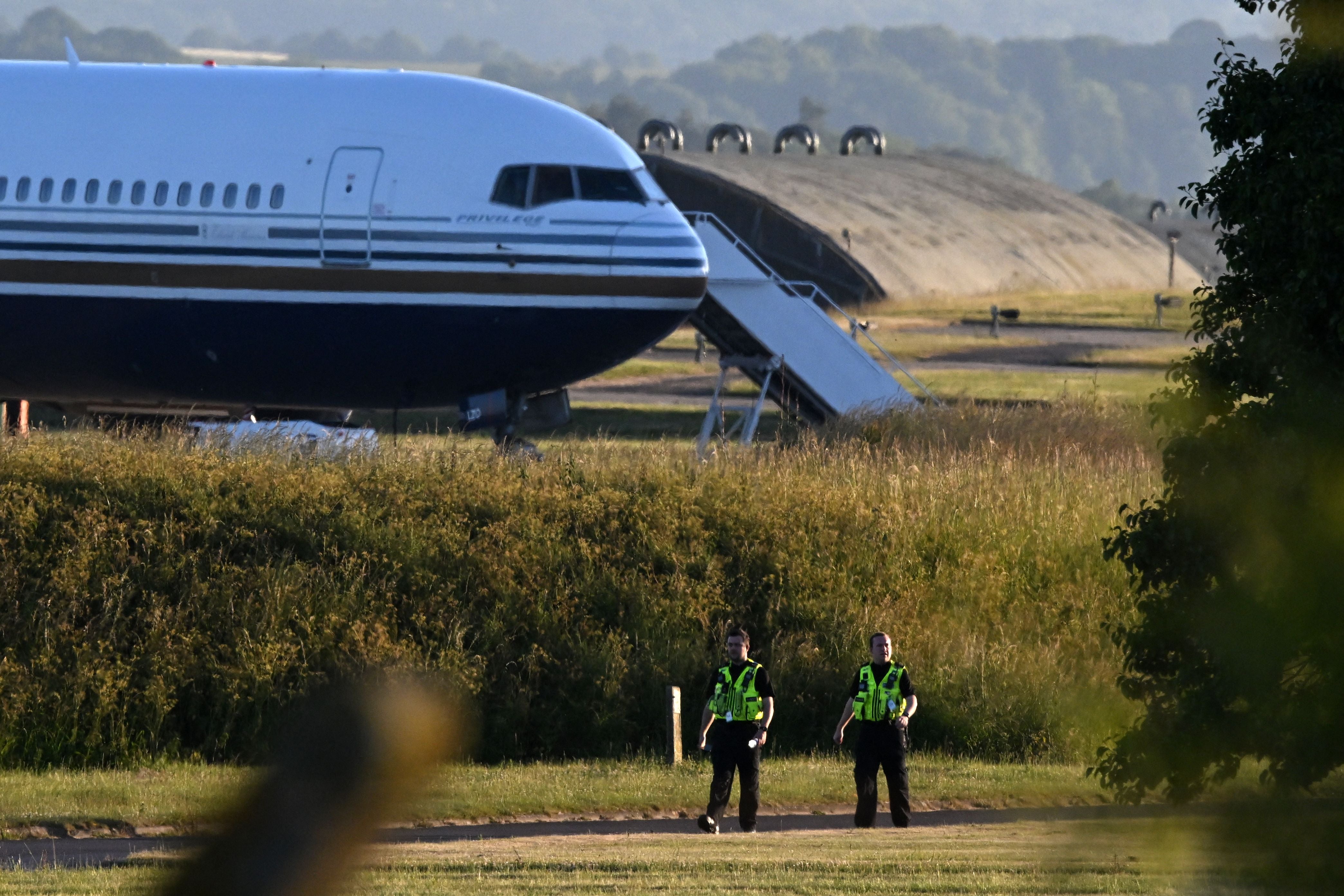 A Boeing 767 sits on the runway at the military base in Amesbury, Salisbury, on 14 June, preparing to take a number of asylum seekers to Rwanda