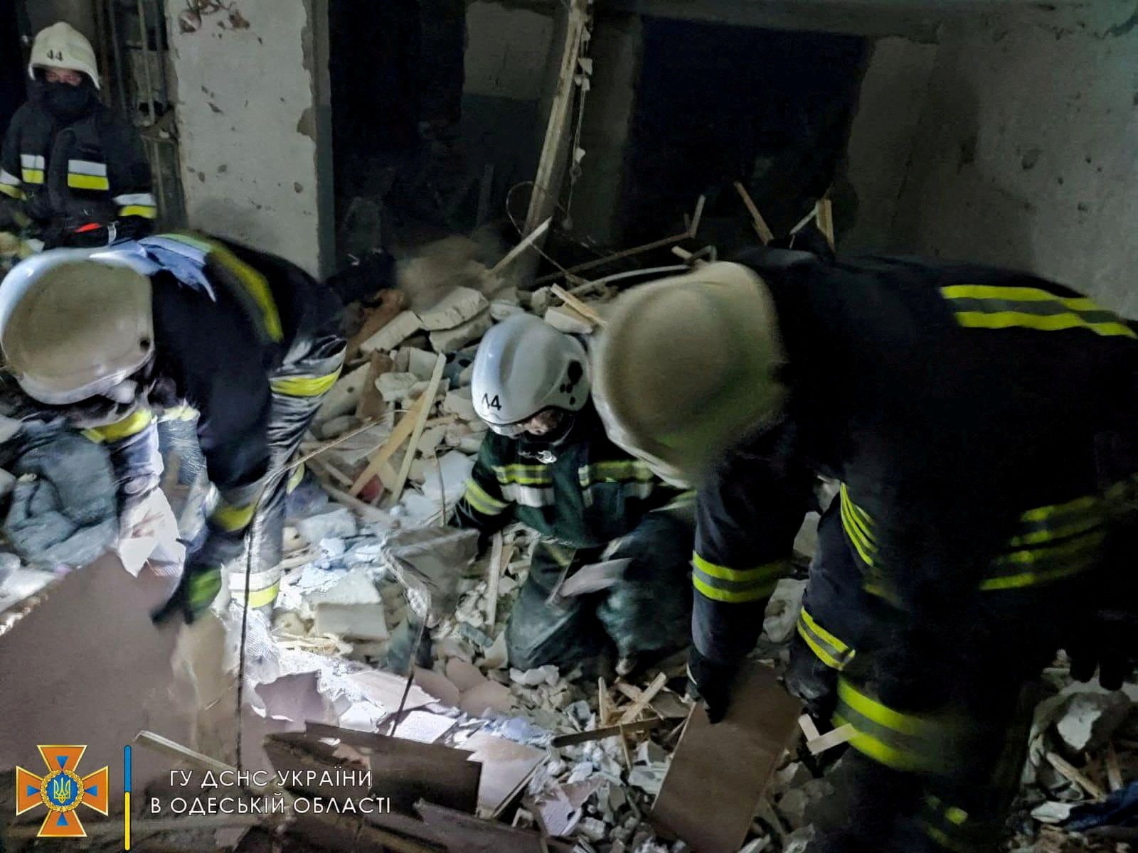 Rescue workers at the scene of a missile strike at a location given as Serhiivka village