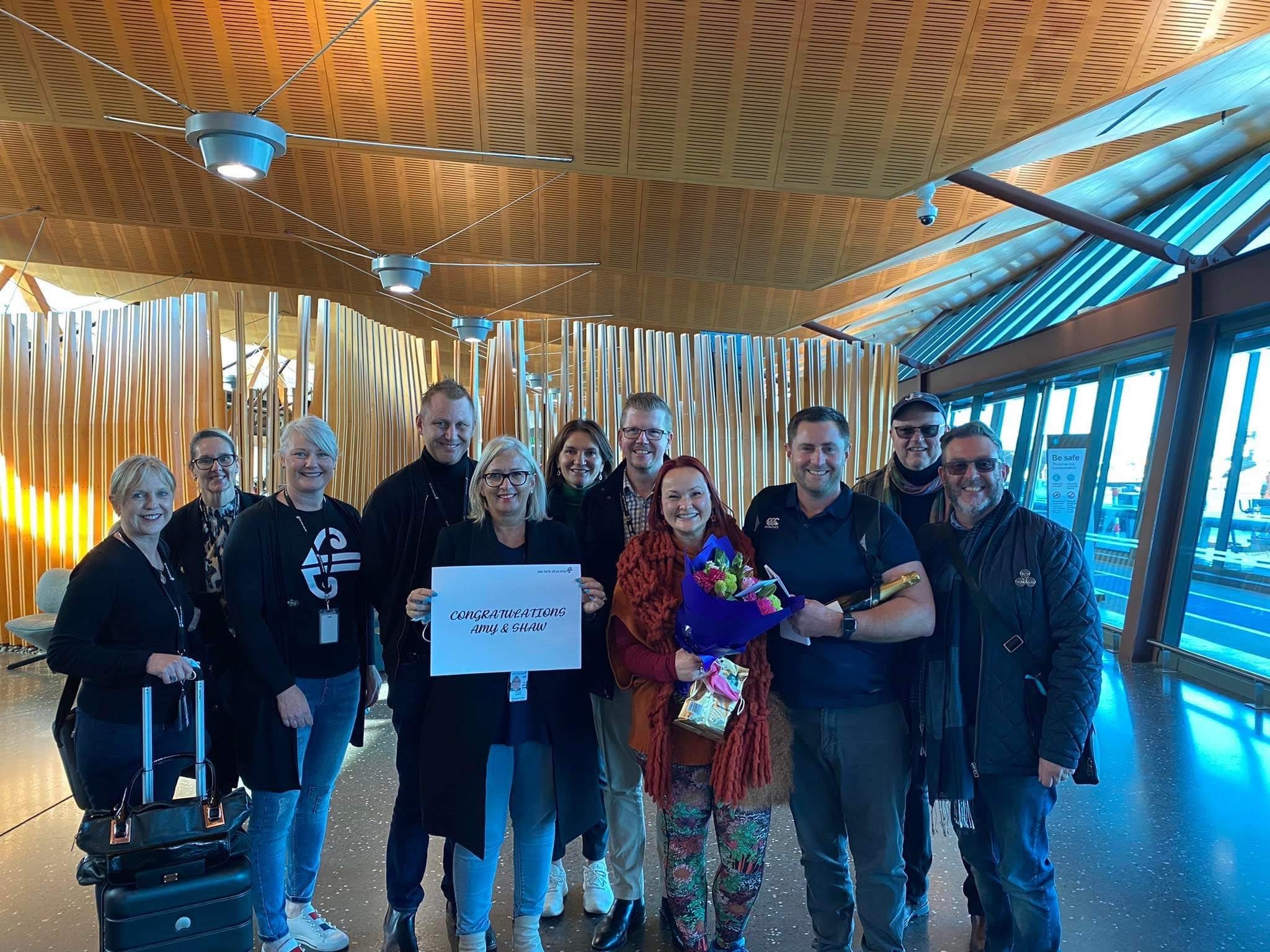 The happy couple with the Air New Zealand team at Christchurch Airport