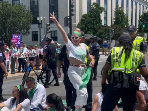 Philipps being arrested outside the Supreme Court