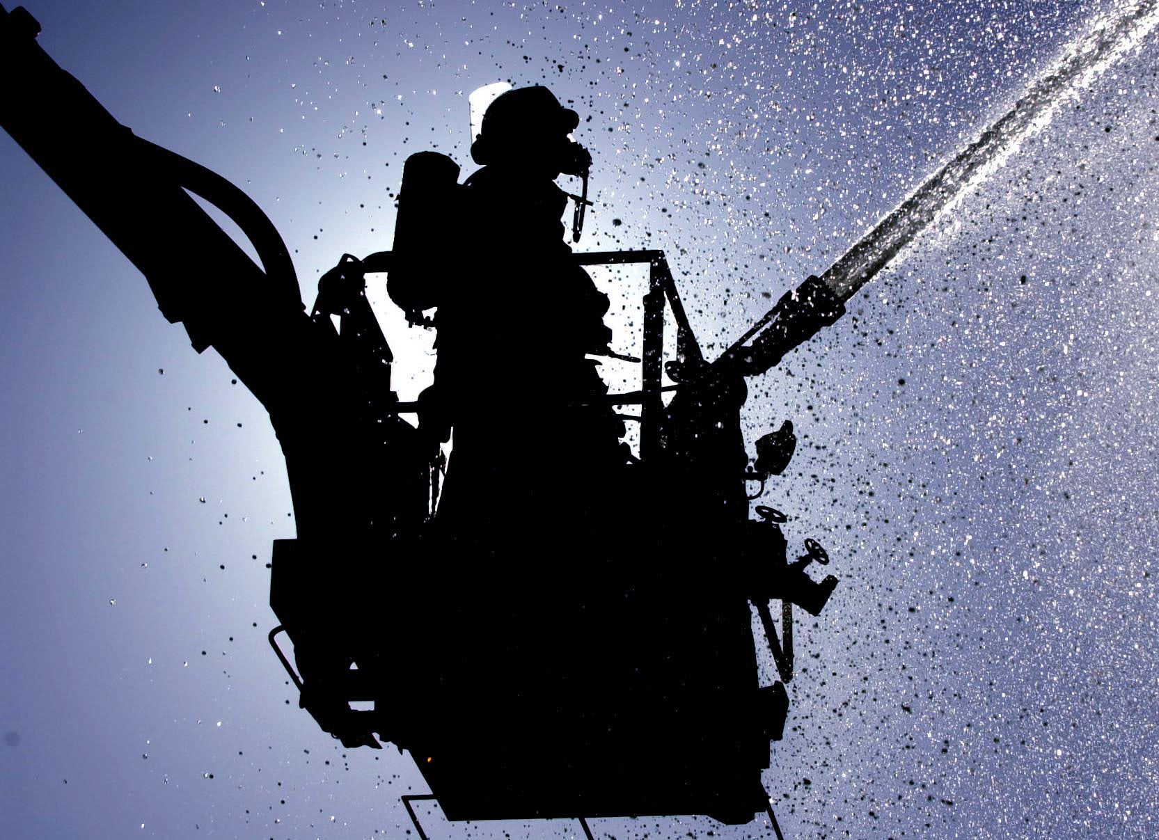 A fireman practises his technique (Rui Vieira/PA)