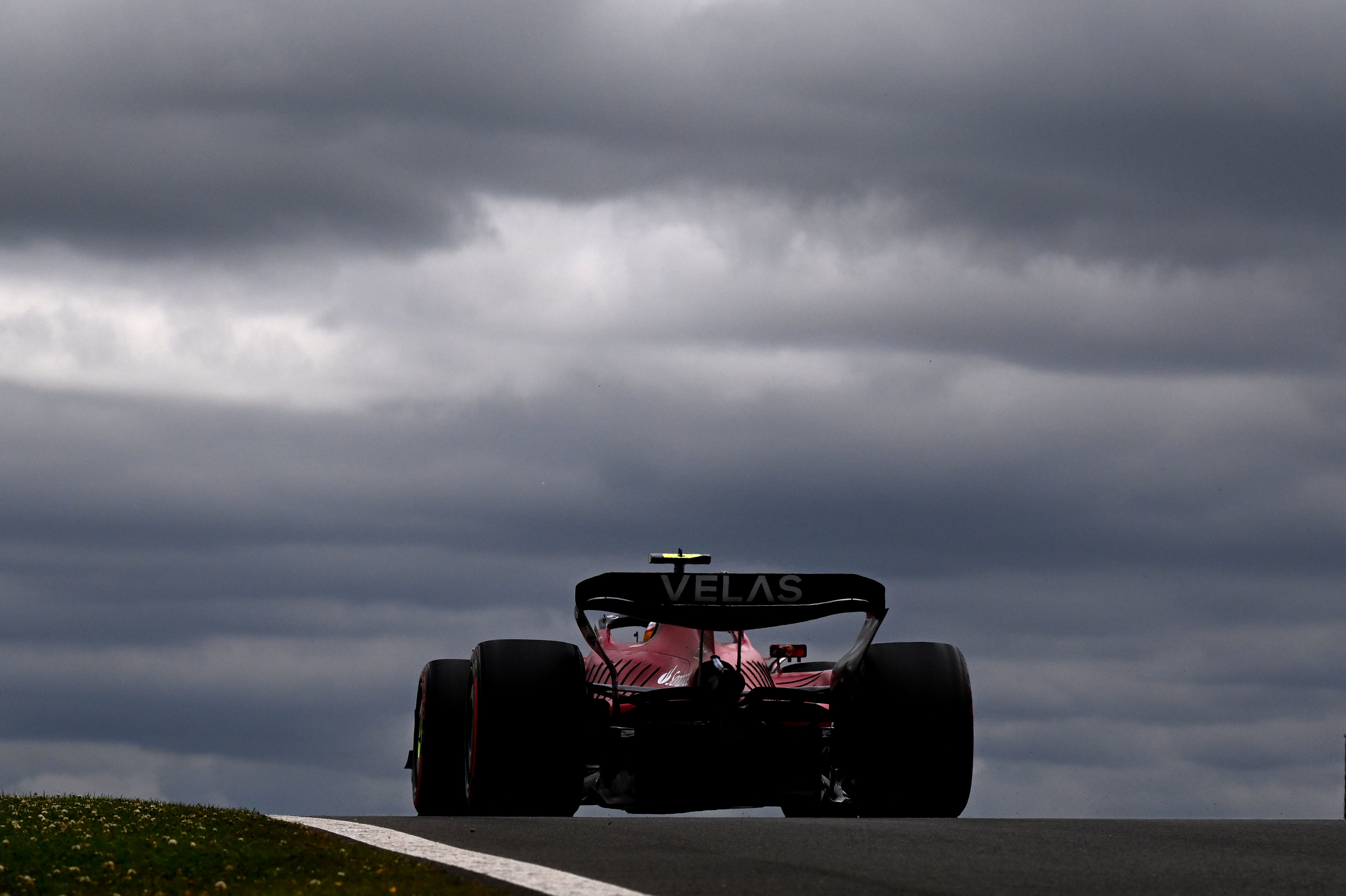 Carlos Sainz drives in final practice under heavy dark clouds...