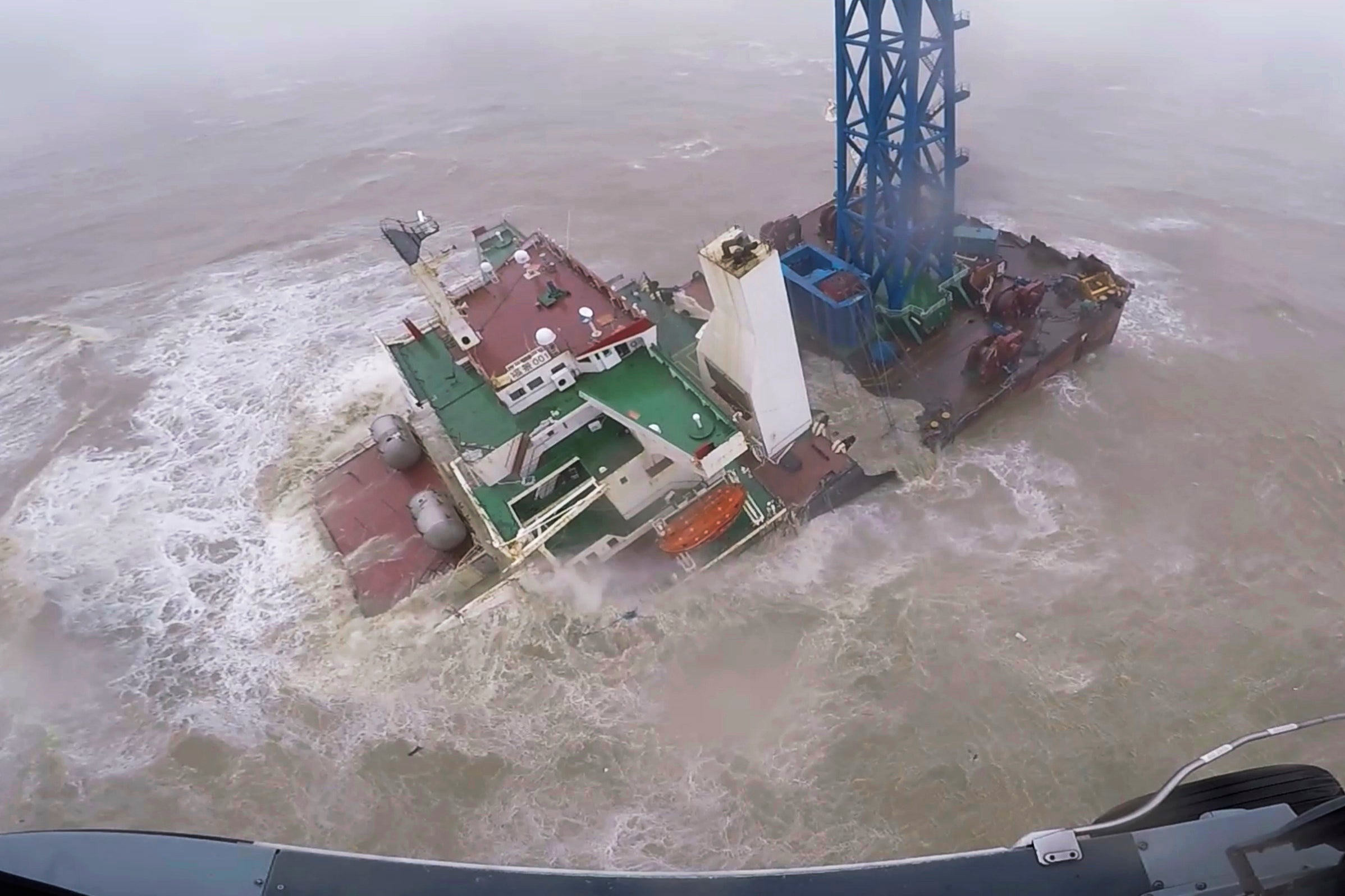 A rescue crew approaches a sinking ship near Hong Kong