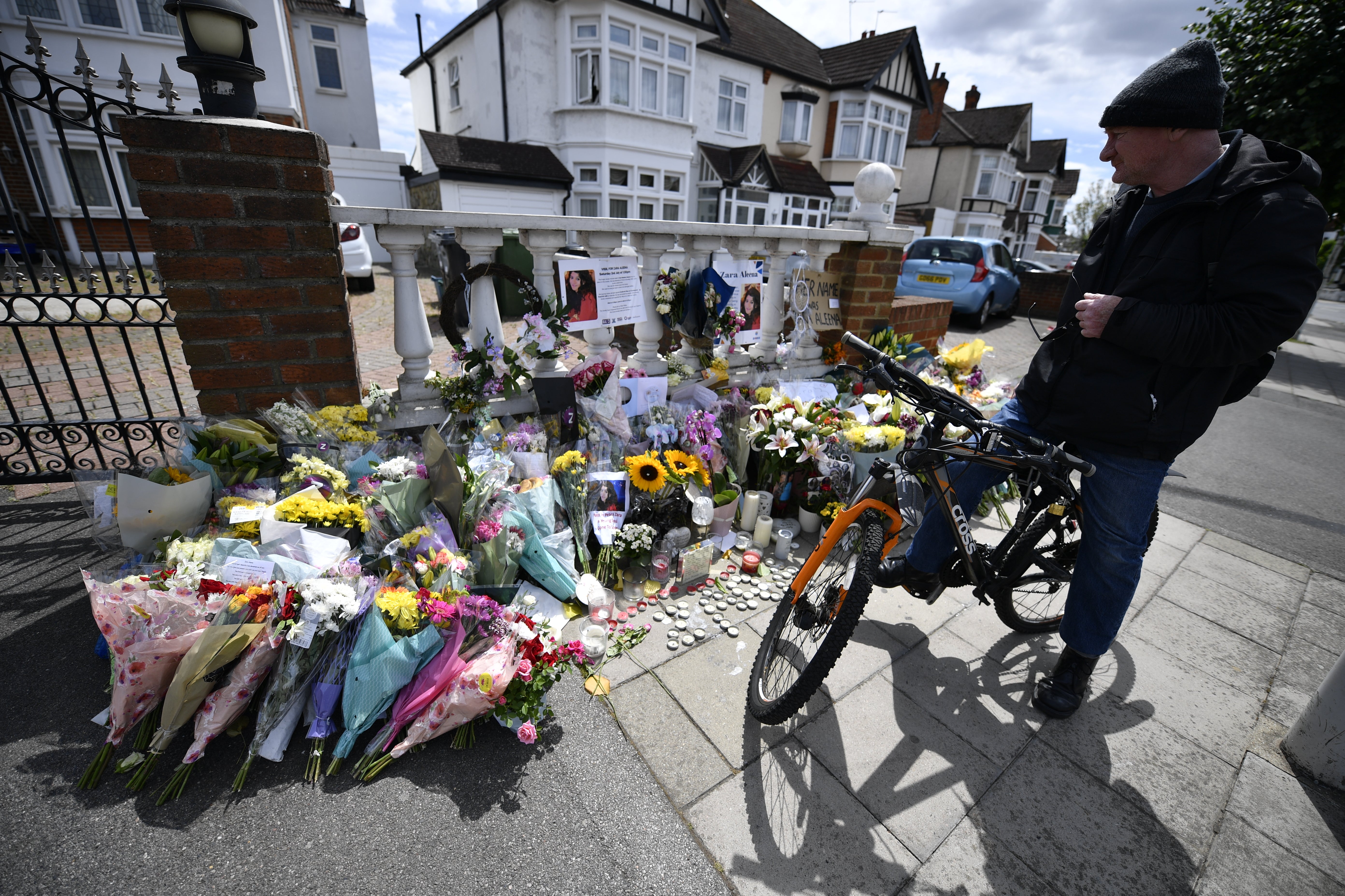 Flowers are left after a vigil for Ms Aleena