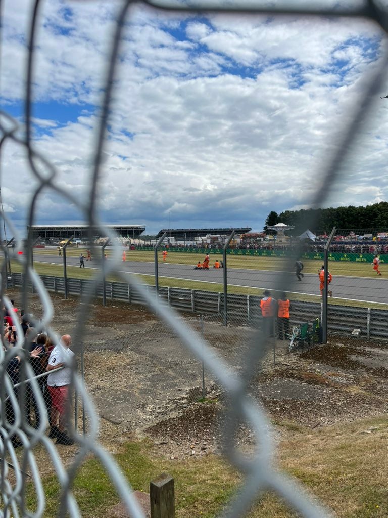 Protestors sit down on the Silverstone track (Helena Hicks/PA).