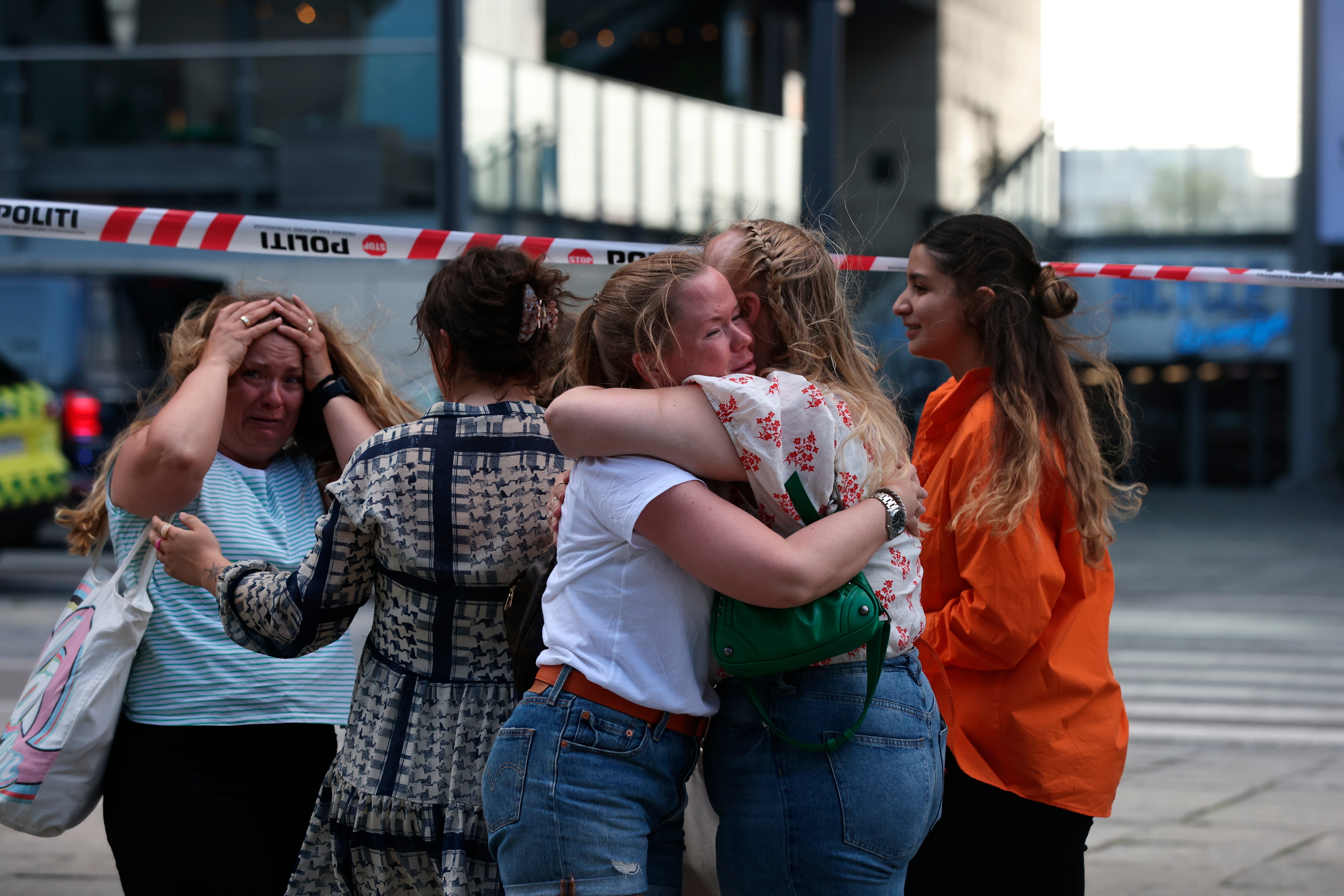 Friends comfort each other after a shooting at a shopping centre in Copenhagen (Olafur Steinar Gestsson/Ritzau Scanpix via AP)