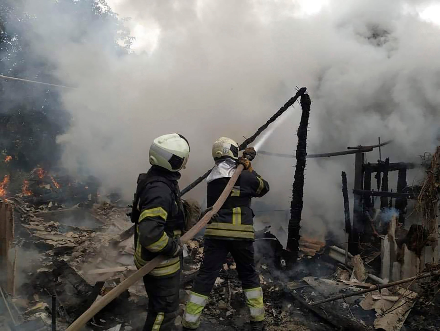 In this photo provided by the Luhansk region military administration, Ukrainian firefighters work to extinguish a fire at damaged residential building in Lysychansk, Luhansk region, Ukraine, early Sunday, July 3, 2022. Russian forces pounded the city of Lysychansk and its surroundings in an all-out attempt to seize the last stronghold of resistance in eastern Ukraine’s Luhansk province, the governor said Saturday. A presidential adviser said its fate would be decided within the next two days. (Luhansk region military administration via AP)