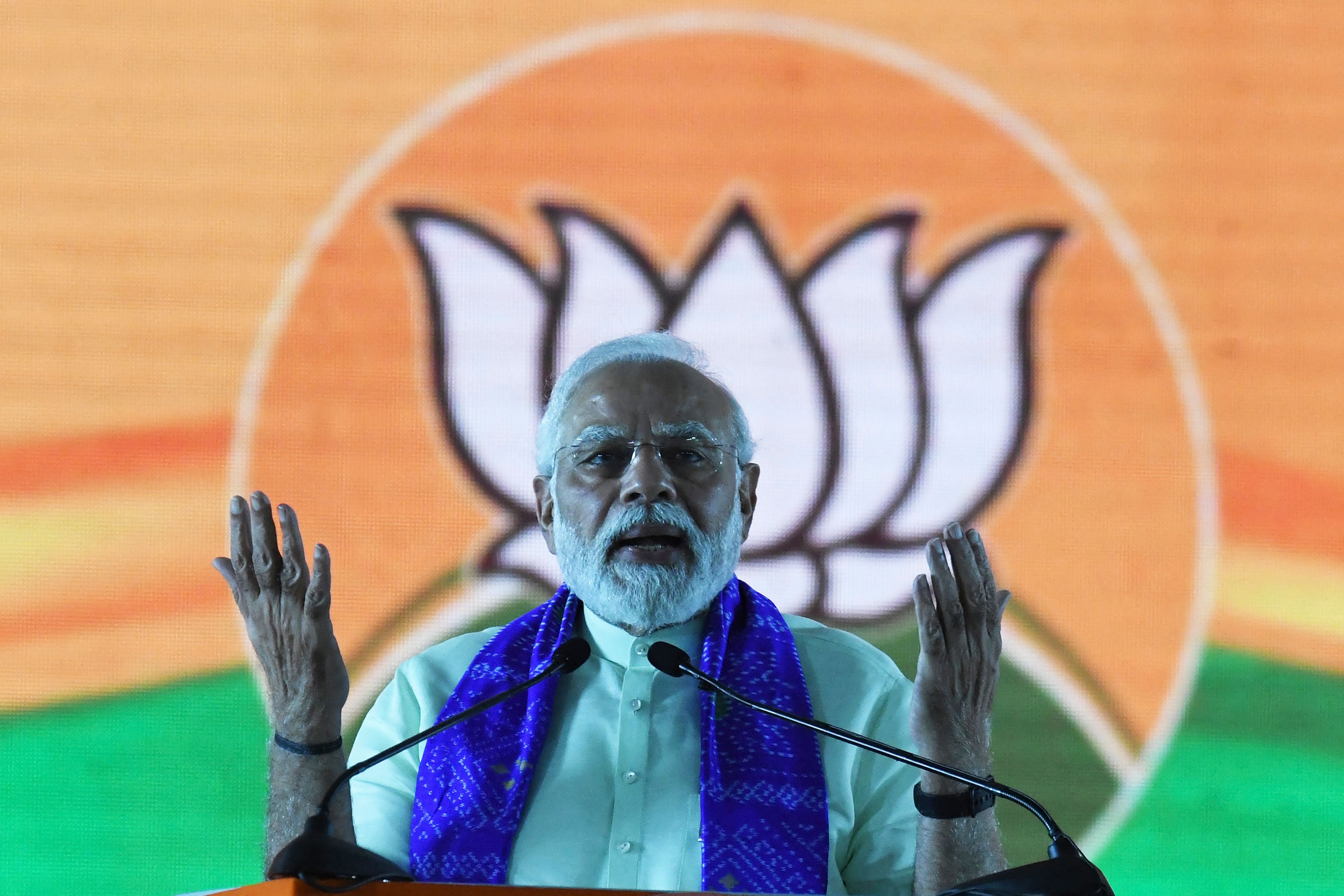 India's Prime Minister Narendra Modi gestures as he addresses a public meeting at parade grounds in Secunderabad, the twin city of Hyderabad