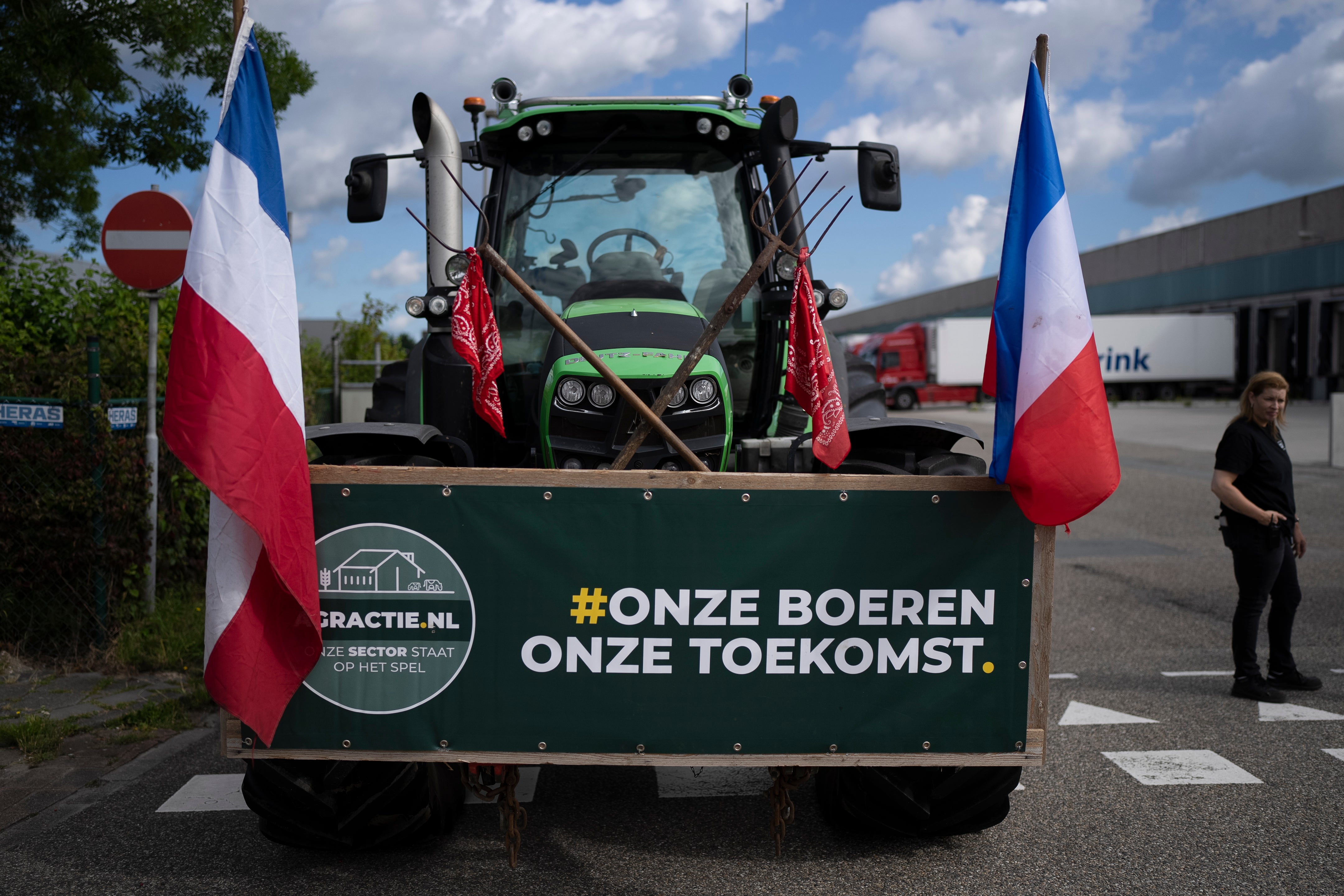 A sign reads ‘Our Farmers, Our Future’ as some 25 tractors form a blockade outside a distribution centre for supermarket chain Albert Heijn in the town of Zaandam, just north of Amsterdam