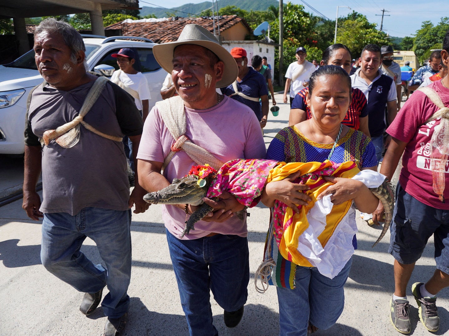 People carry the alligator to the wedding ceremony