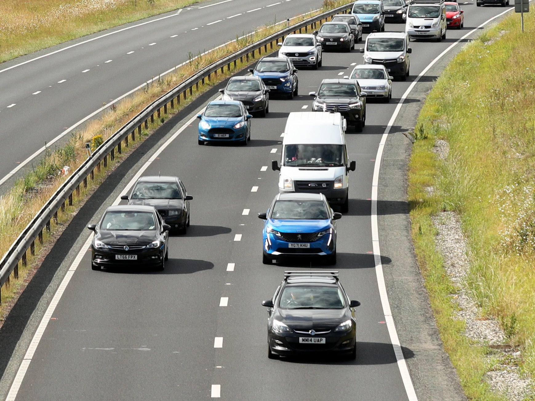 A slow-moving convoy goes down the A64 in York