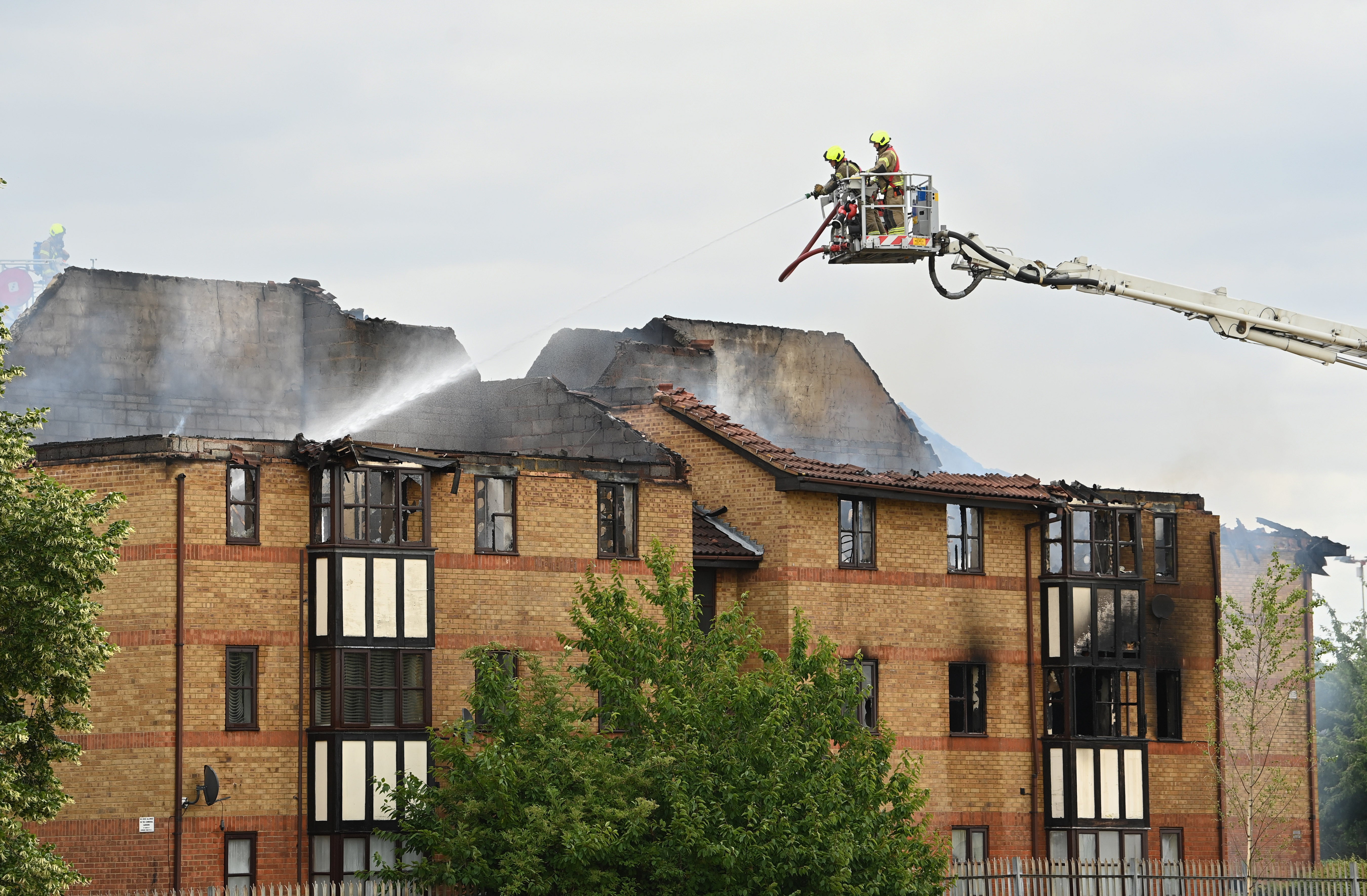 Firefighters at the scene of a gas blast in Redwood Grove, Bedford (Doug Peters/PA)