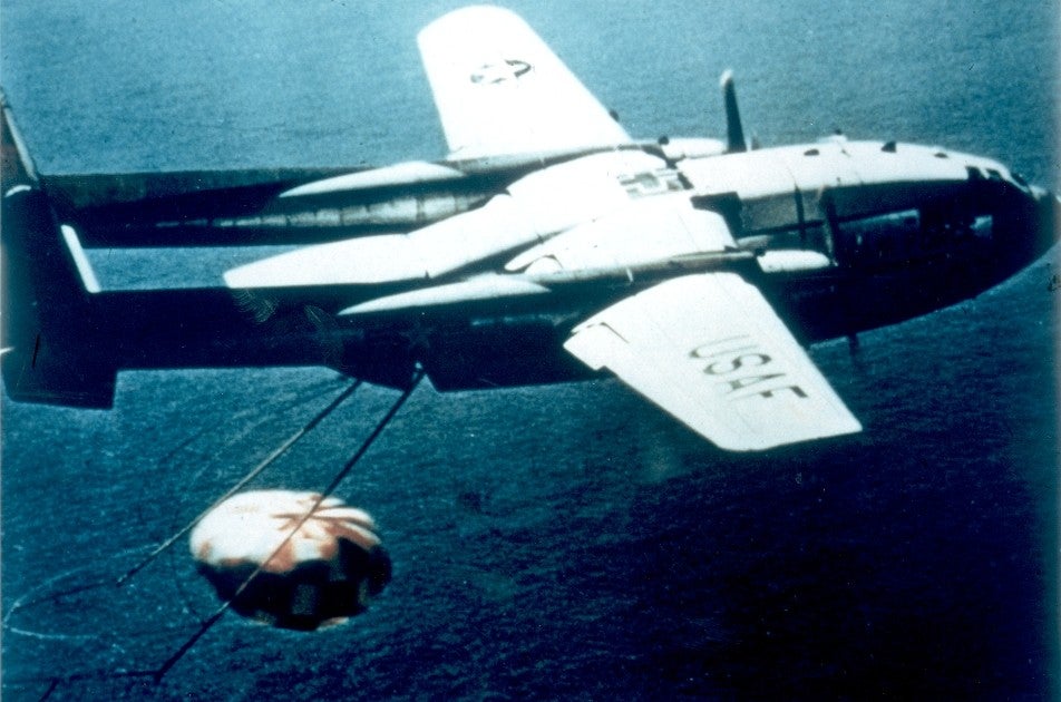 A parachuting film capsule from project Corona is snared by a catcher plane over the Pacific Ocean