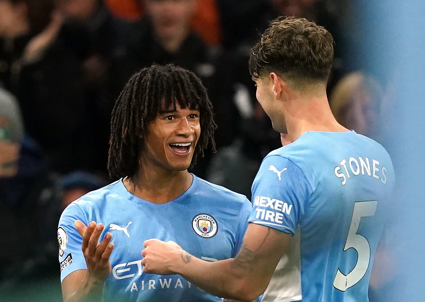 Nathan Ake, left, celebrates with John Stones after scoring against Leeds (Martin Rickett/PA)