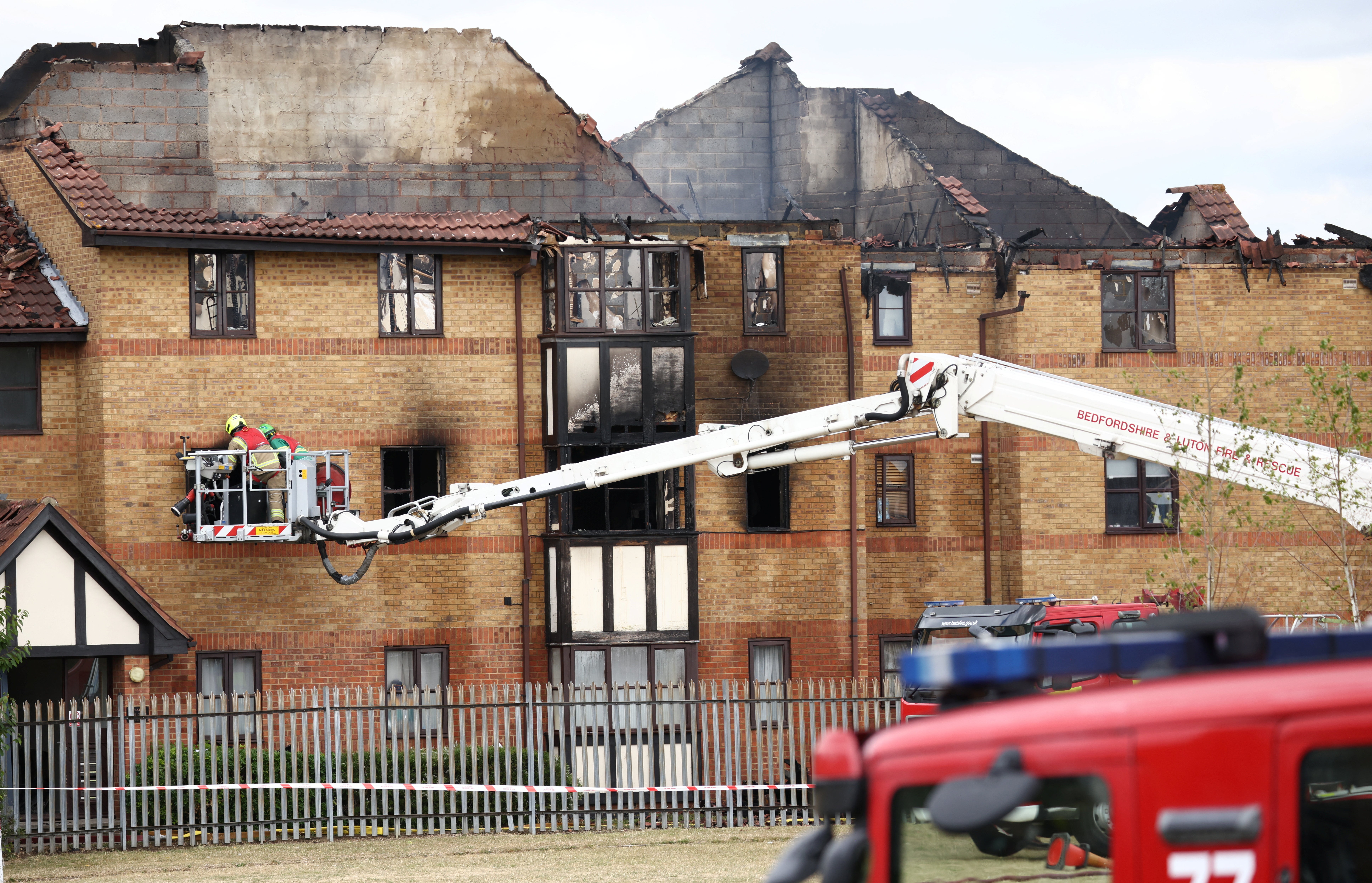 Firefighters work at the scene of a the fire at Redwood Grove following a gas explosion
