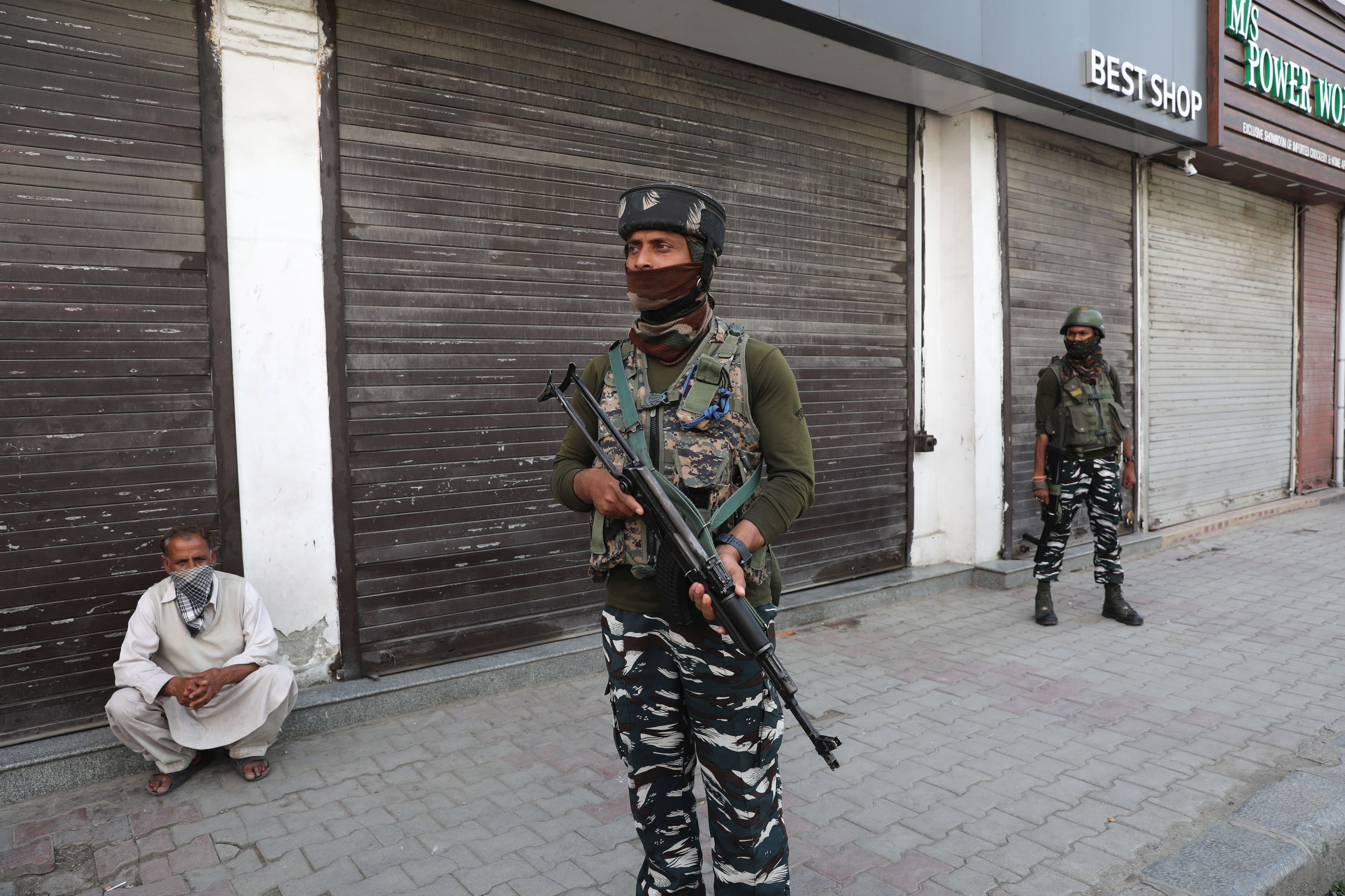 Indian paramilitary soldiers patrol near a closed market during a shutdown in Srinagar