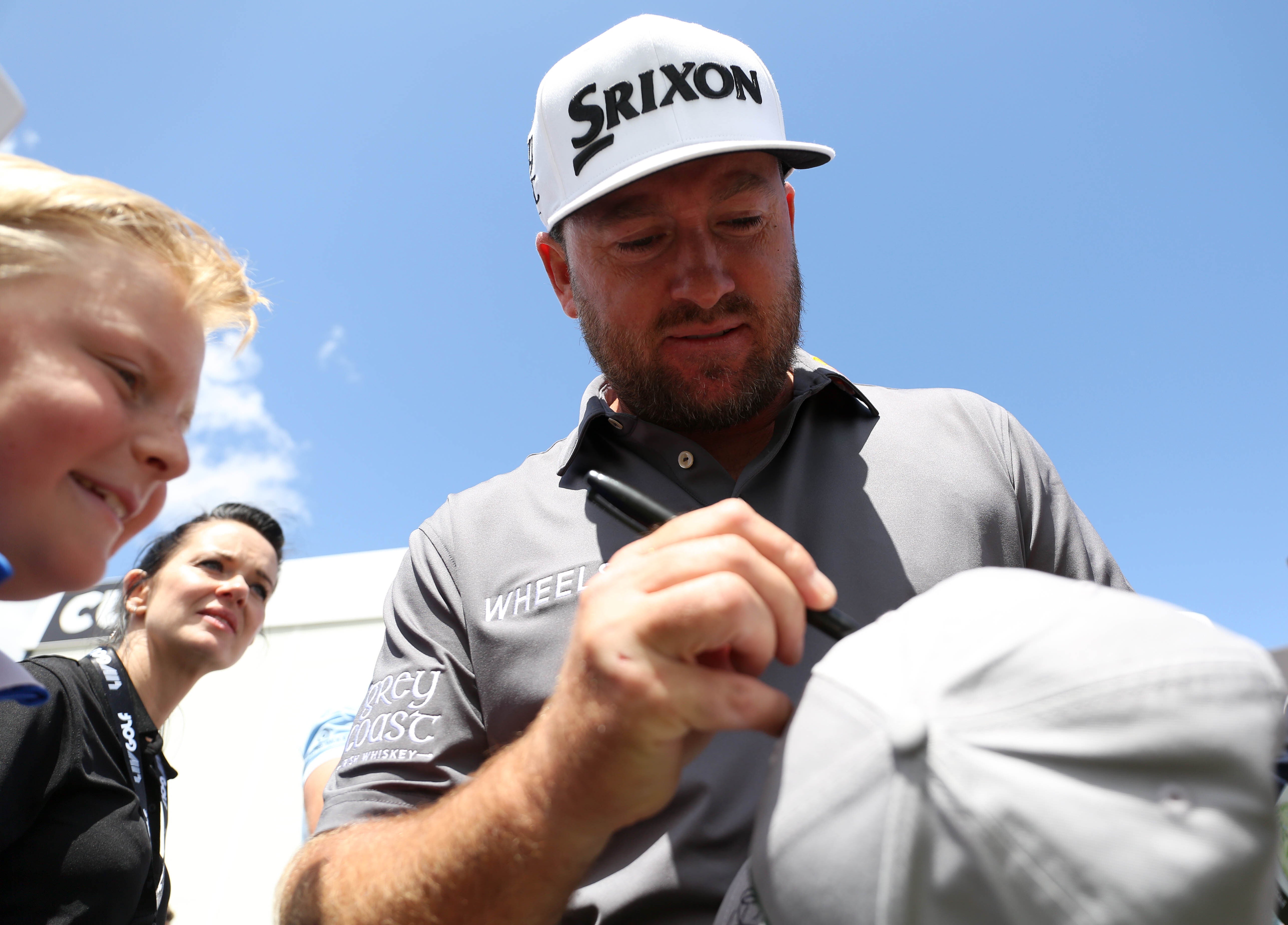 Graeme McDowell signs a hat for a fan (Kieran Cleeves/PA)